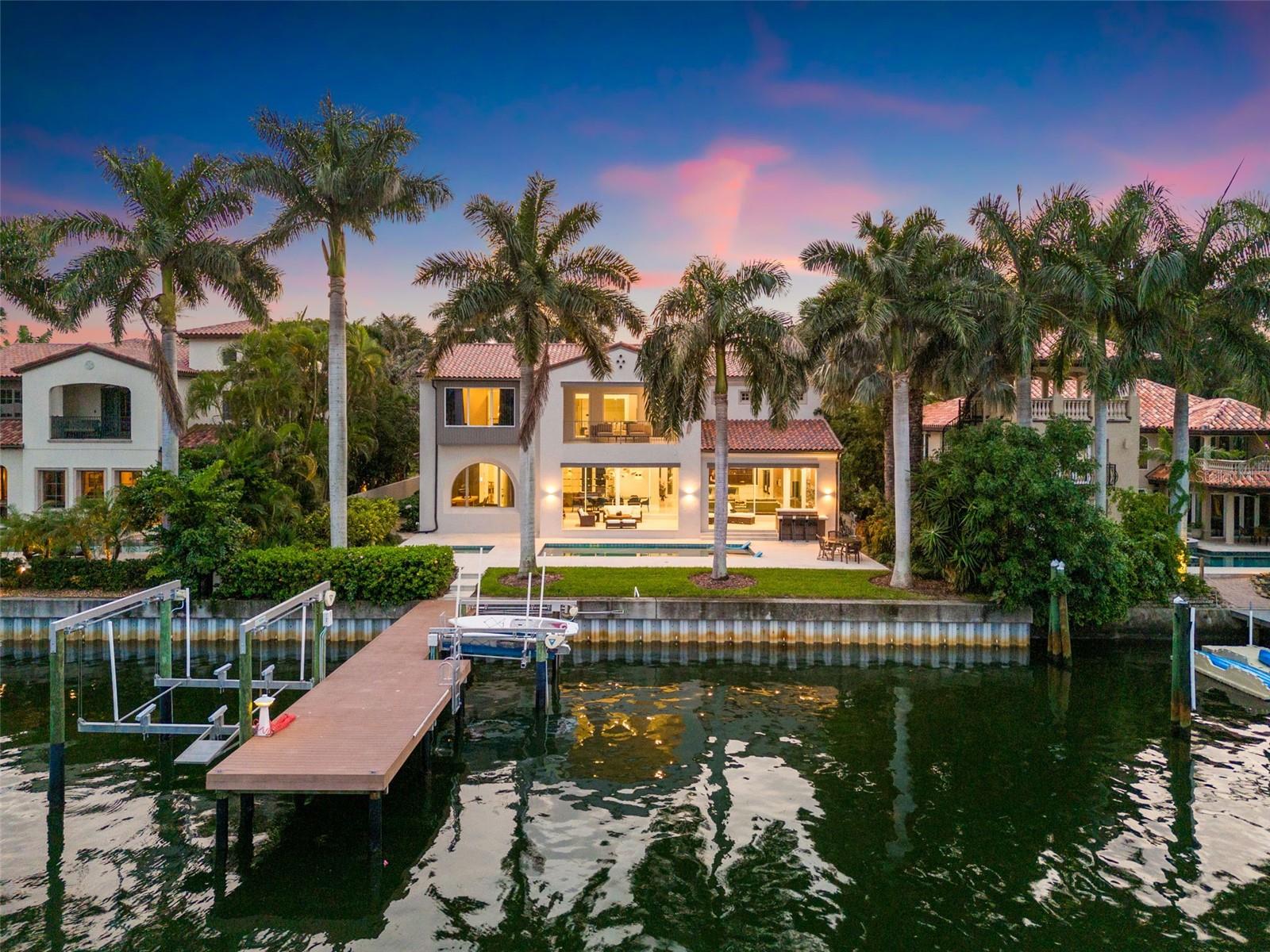 This exceptional WINDSTAR estate, originally built in 2007 and fully reimagined in 2020–2021, is a testament to timeless design, cutting-edge technology, and enduring value. Situated on one of the highest elevations on Brightwaters Blvd., this solid block-constructed home provides peace of mind in all weather, while its whole-home generator ensures seamless living, even when others go dark.
From the moment you enter the private front courtyard, you're met with a sense of curated elegance — every element of this home has been intentionally designed for both comfort and value retention. Inside, imported cabinetry from the Netherlands and sleek hidden drawer systems combine European sophistication with everyday functionality.
The chef’s kitchen features ebony walnut wood finishes, induction cooking, Miele appliances, dual refrigerators, and instant hot water — all chosen for performance and aesthetic longevity. This space flows effortlessly into the living room and outdoor kitchen and lounge, ideal for hosting or relaxing in your private tropical escape.
The main level boasts two executive offices, a wine display, laundry room, drop zone, formal dining, breakfast nook, and two en-suite bedrooms — including a private-entry casita that adds tremendous flexibility for guests, extended family, or rental potential.
Upstairs, the primary retreat offers a spa experience designed by Alberto Apostoli, complete with a Turkish bath, sauna, and heat-resistant Abachi wood shower — rare, wellness-oriented features that elevate the home’s future market appeal. Step onto your private balcony to take in peaceful water views and perhaps a glimpse of manatees gliding through your deep, protected waterfront dock.
The second floor also includes two additional en-suite bedrooms, a cozy flex/media room, and a second laundry area. Italian Elm floors by Garbelotto and lighting from Belgium and the Netherlands further reinforce the home’s bespoke character and enduring materials.
Located just 1.3 miles from downtown St. Petersburg, this property offers the best of both worlds: serene, private waterfront living with proximity to cultural, culinary, and economic vibrancy. North Shore Park is just a short 3-mile bike ride away, expanding your recreational reach.
Homes of this caliber — higher elevation, turnkey, with storm-hardened infrastructure — will become increasingly rare and in demand. This is not only a place to live, but a strategic hold in one of Florida’s most resilient luxury enclaves.
Recently named one of the “Top 15 Happiest Places in the US” by Outside Magazine, St. Petersburg offers unmatched lifestyle and economic opportunity — and this home positions you perfectly for both.