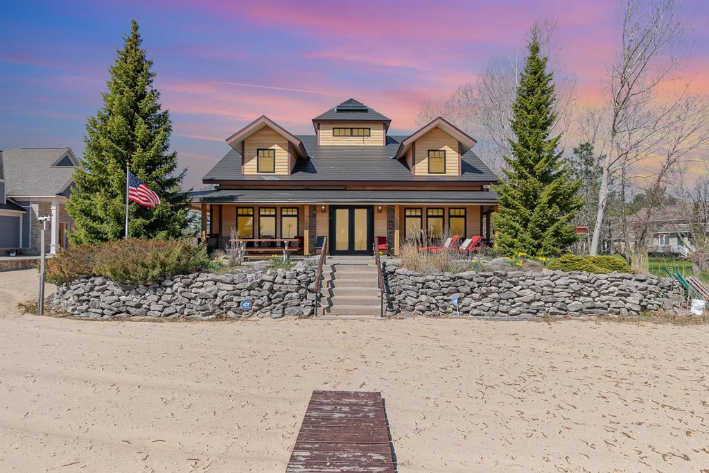 Welcome to an extraordinary lakefront estate that defines elegance, craftsmanship, and the pinnacle of coastal living. This one-of-a-kind 5 bedroom, 6 bathroom home spans over 6,000 square feet and boasts 90 feet of pristine, sandy shoreline on the breathtaking waters of Lake Huron, while located near Oscoda's quaint downtown. A property of this caliber-designed with enduring commercial-grade materials and elevated architectural design-is truly irreplaceable at this price point. Built for beauty and longevity, the exterior features cement-board siding, a doubly-insulated crawl space, heated driveway pad, a metal roof, and whole-property generator. These amenities are just a taste of the endless list of sublime materials used here to deliver minimal maintenance, and withstand the test of time. Inside, the home is a showcase of light and artistry, with oversized windows, a dramatic three-story solarium at its heart, and striking architectural details throughout. On the main floor, the primary suite is a serene sanctuary, with a spa-inspired ensuite and generous walk-in closet. A custom fieldstone fireplace in the living room, chef's kitchen with commercial appliances, and plenty of room for everyone, all overlook the sandy shoreline. Radiant heating runs beneath the floors of both the home, apartment, and garage, and zoned AC offers year-round comfort. Ample storage is seamlessly integrated into every corner of the home, with abundant closets, shelving, and built-ins designed for elegant practicality. Above the oversized three-car garage is a separate apartment with its own kitchen and double-sided fireplace-making hosting guests effortless. There are truly too many unique features to list-please see the detailed upgrade list. Immerse yourself in all lake life has to offer with this luxurious estate. Dont miss your chance to own this rare masterpiece.