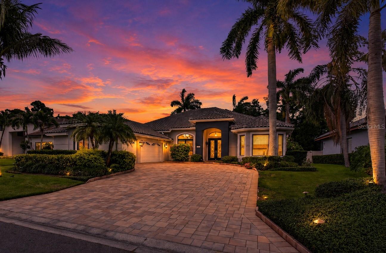 Welcome to an extraordinary waterfront retreat in the coveted 24-hour guard-gated community of Placido Bayou. Custom-crafted and impeccably maintained, this stunning single-story residence seamlessly blends timeless design, luxury amenities, and exceptional boating access. Constructed of solid block and thoughtfully updated, the home features four bedrooms, three baths, a concrete tile roof (2019), Generac whole-house generator, solar panel system (seller owned), dual Trane HVAC systems with dehumidifiers, a three-car garage (with 220-volt outlet for EV car charging), and a screened pool enclosure designed for year-round enjoyment. Boating enthusiasts will appreciate the exceptional composite dock, complete with an extremely rare, covered boathouse, 10,000-pound lift, kayak launch, water and electric service, concrete-anchored pilings, and direct access to Tampa Bay. Inside, an elegant open-concept floor plan unfolds around the resort-style pool terrace, creating seamless indoor-outdoor living. Soaring vaulted ceilings, abundant natural light, and formal living and dining spaces provide both comfort and sophistication. The deluxe chef's kitchen is beautifully appointed with new marble countertops, stainless steel appliances, wine fridge, a walk-in pantry, breakfast nook, bar seating, and a private office corridor ideal for working from home. The luxurious owner's retreat serves as a private sanctuary, featuring a spacious sitting area, spa-inspired bath, and French doors that open directly to the pool and lanai. Additional enhancements include a premium surround-sound system that extends throughout both the interior and outdoor entertaining areas. Designed for effortless entertaining, the screened lanai showcases a sparkling PebbleTec saltwater pool and spa with propane heat, wet bar, dining space, and multiple lounging areas surrounded by lush tropical landscaping. Beyond the pool, a fenced backyard and winding paver pathways lead to the waterfront, creating a private oasis for family, guests, and pets alike. Residents of Placido Bayou enjoy a serene, nature-filled setting with miles of scenic walking and jogging paths, tranquil lakes, abundant wildlife, and 24-hour guarded security. Ideally located just minutes from downtown St. Petersburg, top-rated schools, the Racquet Club of St. Petersburg, the vibrant 4th Street corridor, I-275, and the Gandy Bridge, this exceptional waterfront property offers the perfect balance of privacy, convenience, and the ultimate Florida lifestyle. Seller will provide Buyer with current clean 4 point inspection for additional peace of mind. Buyer to verify all measurements, HOA, and community regulations and information.