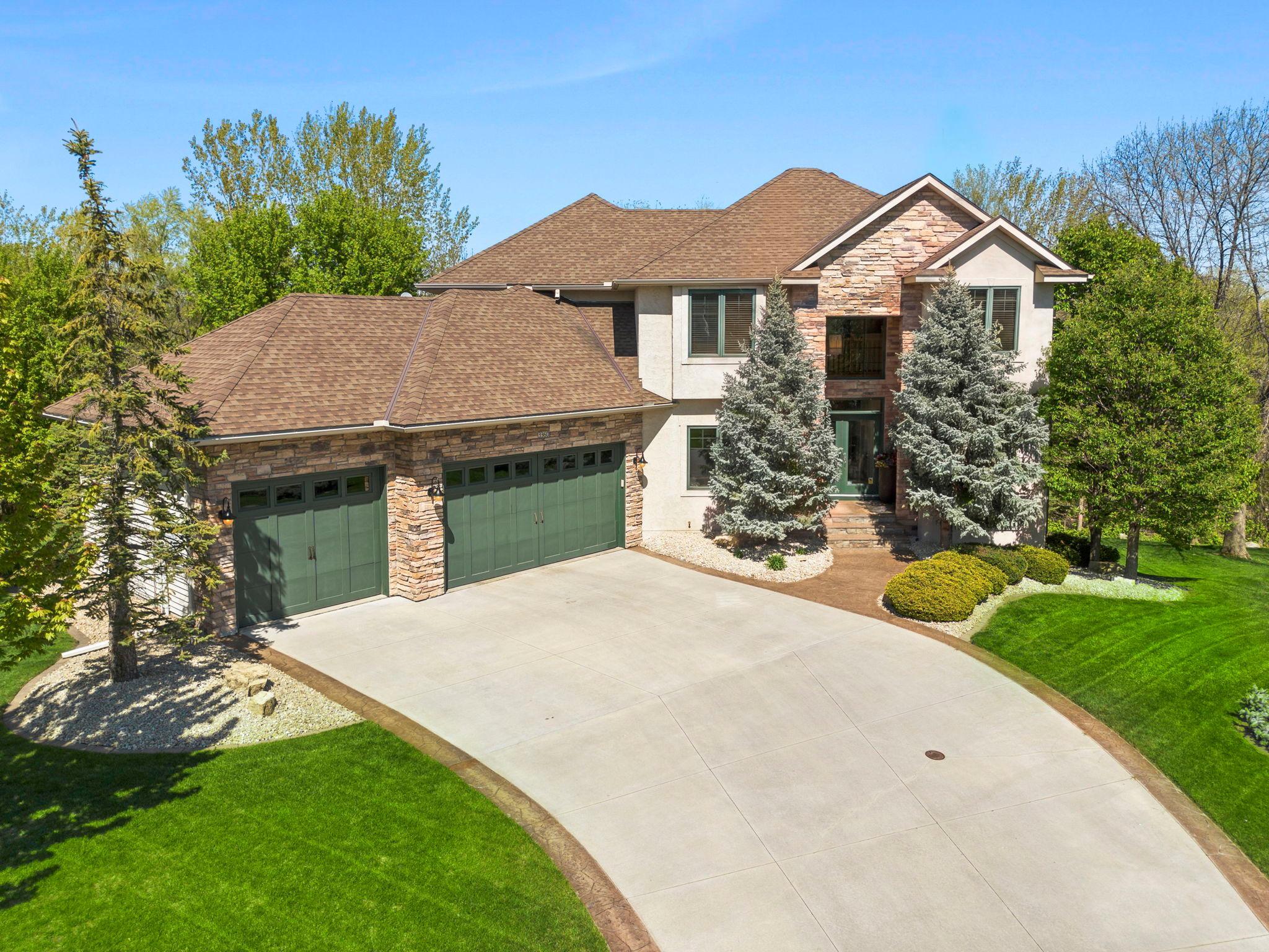 Welcome to this stunning three-bedroom, three-bathroom home featuring exceptional design, a thoughtful layout, and meticulous care by its original owner, along with recent updates. Located in the quiet Wilds community of Prior Lake, the home offers privacy, mature trees, frequent wildlife, and access to scenic walking paths, Wilds Park, a clubhouse, golf course, and community events. Southern exposure fills the home with natural light.A welcoming entry with double French doors opens to a bright two-story foyer leading into the great room with updated luxury flooring (2022), a double-sided gas fireplace, floor-to-ceiling shelving, and large windows. The chef’s kitchen features wood cabinetry, quartz countertops (2022), a spacious breakfast bar, updated fixtures, and black appliances including a double oven and cooktop. It flows into the dining area and out to a two-tier maintenance-free deck for entertaining.The main level also includes a vaulted living room with a second fireplace, a formal dining room with built-ins and stylish finishes, a dedicated office with backyard views, a laundry room with storage and garage access, and a half bathroom. Upstairs offers three bedrooms, including a spacious primary suite with tray ceilings, new carpeting (2026), a large walk-in closet with built-ins, and a spa-like bath featuring dual vanities, quartz countertops (2022), a jetted tub, and a tiled walk-in shower. Two additional bedrooms include built-in storage and share a full bath with quartz vanity and tub/shower combination. The unfinished lower level provides excellent expansion potential with walkout access. The backyard is a standout, featuring a paver patio, firepit area, updated landscaping, string lighting, limestone accents, and mature trees for privacy.A rare opportunity in a highly desirable location.