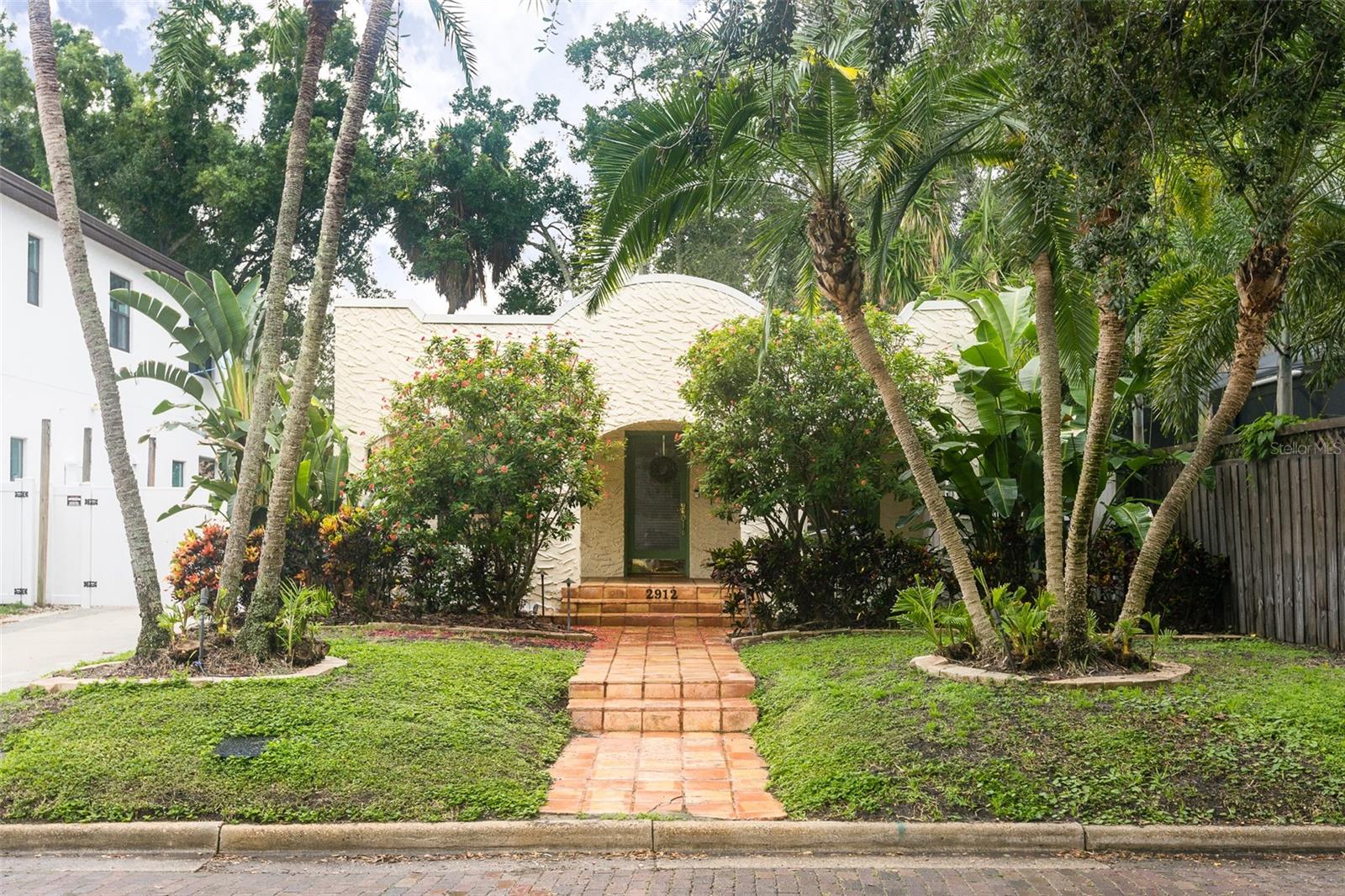 Don't miss this 1920s Mediterranean style Bungalow. The front porch welcomes you as you enter the home, into the spacious living room featuring a wood-burning fireplace and original built-in shelving. Off the living room, through french doors is a light and bright office. The generous dining room has ample room for entertaining. The well-equipped kitchen includes double door pantry, breakfast bar, and plenty of storage. The primary bedroom has a walk-in closet, and french doors overlooking the backyard brick patio. In addition to the charming patio, get your golf clubs out and enjoy the turf putting green. Coveted location is walking distance to multiple Tampa staple restaurants such as Bella and Bern's as well as Palma Ceia Country Club.