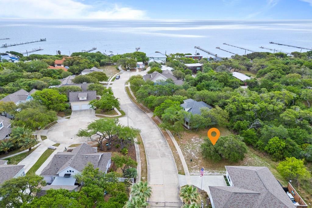 Discover an exceptional homesite in the highly sought-after gated waterfront community of The Boardwalk on Fulton Beach Road. Ideally positioned between Highway 35 North and Fulton Beach Road, this premier lot offers the perfect canvas to build your coastal dream home.  Surrounded by natural beauty and coastal charm, residents enjoy exclusive access to a secluded private community pool and a scenic fishing pier stretching out into Aransas Bay—perfect for sunrise views, evening breezes, and casting a line just steps from home.  This intimate, private enclave is designed for those who value tranquility, security, and a refined coastal lifestyle. Whether you're envisioning a full-time residence or a serene getaway, this homesite offers the rare opportunity to create your own piece of paradise in one of the area's most desirable waterfront communities.