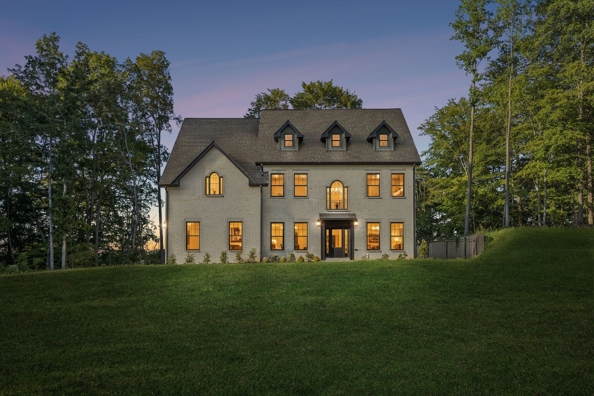 Set in prestigious Port Royal Estates, this stunning new construction residence offers over 3,700 square feet with 5 beds and 3 baths on 4.18 acres, is a masterful expression of architecture, craftsmanship, and design. Brought to life by Adams Crafted Homes, this home is thoughtfully envisioned with refined finishes, sophisticated materials, and an effortless sense of luxury throughout. Inside, expansive living spaces are filled with natural light and anchored by soaring ceilings, bespoke details, and seamless indoor outdoor flow. The main level is centered around a stunning chef’s kitchen with an oversized quartz island, Z Line stainless steel appliances, custom cabinetry, apron sink, and a fully appointed pantry. A private office, formal dining, spacious living room, main floor bedroom with bath and covered terrace overlooking the bluff view with mature trees lining the backyard that offers privacy and serenity to complete the main floor. The upper level includes a tranquil primary suite with a spa inspired bath and an extraordinary walk in closet and three additional bedrooms with en suite baths. This property is truly one of a kind in every way. Don't miss the opportunity to own a piece of paradise in the heart of TN.