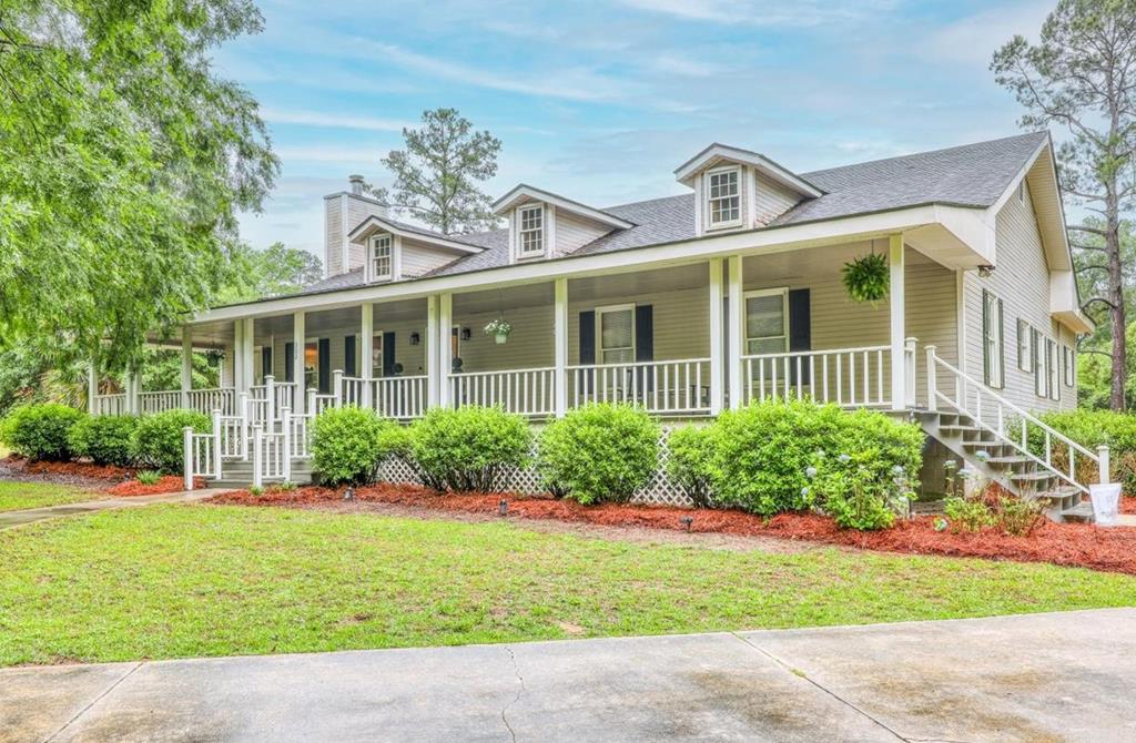 Unbelievable home on 2.7 private acres in Quitman, Georgia! Tucked away for peace and privacy, this South Georgia gem offers the perfect blend of charm, comfort, and space with beautiful hardwood floors, large yards, and an inviting layout designed for everyday living and entertaining alike. Enjoy peaceful mornings and relaxing evenings from the classic rocking chair front porch, or unwind on the cozy back porch overlooking the serene property.  Inside, you'll find updated bathrooms, a large master suite, a bright office filled with natural light, a spacious pantry, and warm living spaces full of character and comfort. Outside, the impressive two-story workshop and storage building provide endless possibilities for hobbies, storage, equipment, or a future workspace.  If you've been searching for a private retreat with acreage, charm, and functionality, this rare Quitman property is one you don't want to miss.