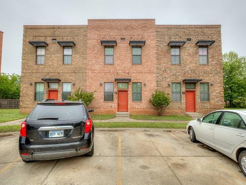 Welcome to Old Towne Lofts in East Norman, located less than 5 minutes away from the OU campus! This stunning and sleek 2-story condo features 2 spacious bedrooms, 2 baths upstairs, and 1 half bath off of the living area downstairs. The concrete flooring throughout the first level gives the home a cool, industrial vibe. The galley kitchen comes with granite countertops and breakfast bar, glass tiled backsplashes, and all electric appliances that include a refrigerator, microwave, and smooth top stove. You'll also have the convenience of a stackable washer and dryer tucked away off the dining space! Upstairs, each bedroom comes with wood flooring and its own full bathroom for privacy! The private back patio is accessible right off the kitchen and has plenty of room for a grill plus outdoor furniture! This condo is maintenance-free with water and trash service, exterior and lawn care covered by the HOA.