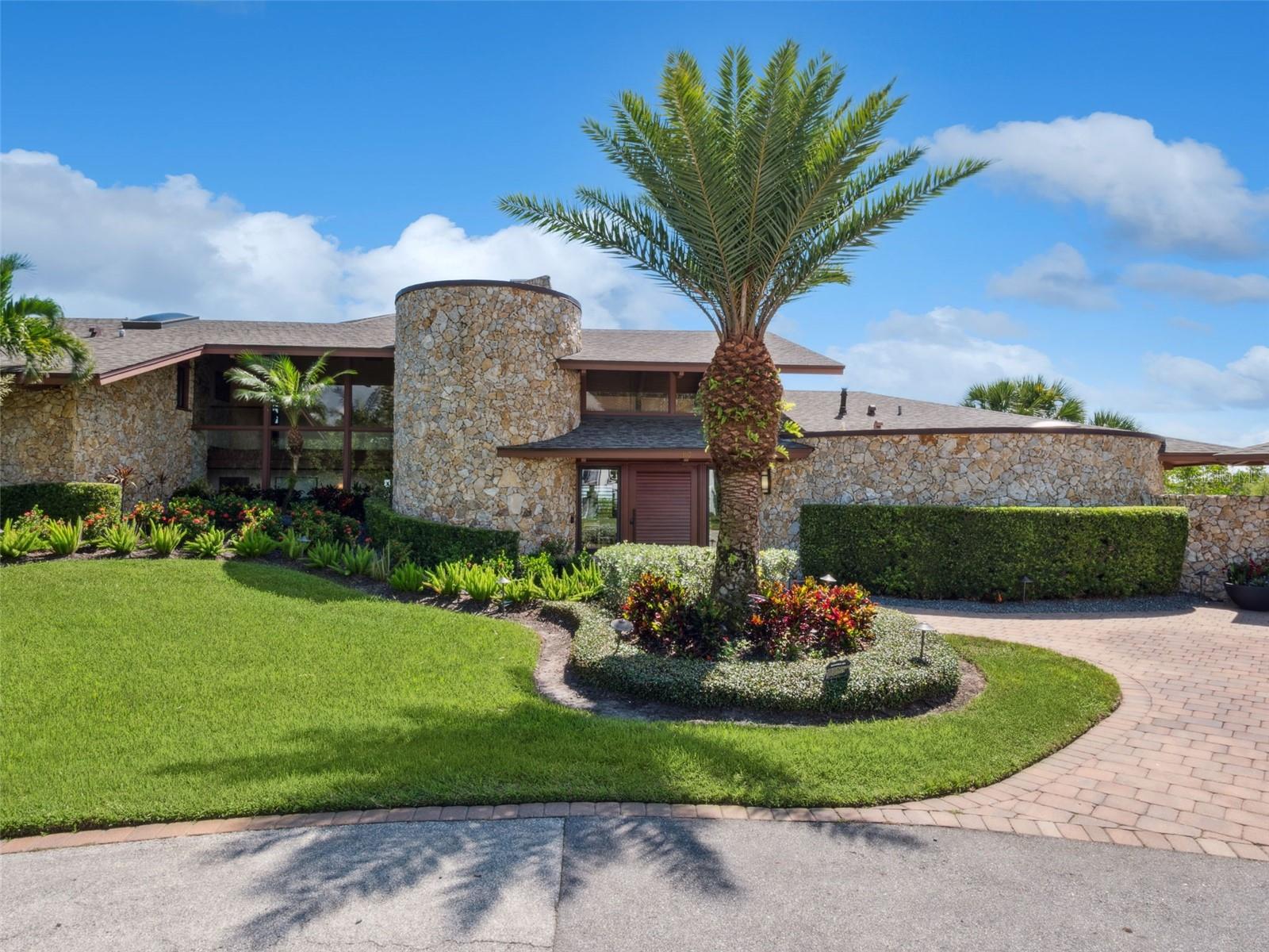 Experience the pinnacle of coastal luxury living in this extraordinary modern estate, a true architectural masterpiece designed by renowned architect Will Miller. Perfectly positioned along the pristine Intracoastal Waterway in New Smyrna Beach, this rare offering captures the essence of refined waterfront living with every imaginable amenity at your fingertips. Set on a lushly landscaped parcel with sweeping water views, this one-of-a-kind, fully furnished compound includes a spectacular main residence and an equally impressive guest house, together offering a total of 5 bedrooms, 5 full bathrooms, 2 half bathrooms, and an oversized 6+ car garage, ideal for auto enthusiasts, collectors, or those seeking ample space for recreational hobbies. The main home is a statement of modern elegance, featuring 3 spacious bedrooms and 3 spa-inspired bathrooms, all thoughtfully designed to maximize comfort and showcase panoramic views. At the heart of the home lies a chef's dream kitchen equippedWith top-of-the-line appliances, custom cabinetry, and sleek stone surfaces. Additional spaces include a dedicated media room, private office, versatile bonus room, and the showstopping "Sky Room", a glass-wrapped retreat offering breathtaking 360-degree vistas of the water and surrounding landscape. The guest residence mirrors the architectural brilliance of the main home, offering 2 bedrooms, 2 bathrooms, private balconies, its own Sky Room, and a fully appointed recreation and fitness center, perfect for hosting guests or accommodating extended family in total privacy and comfort. Step outside to your own private resort, where a self-cleaning saltwater pool with waterfall spa invites relaxation. Enjoy a host of resort-caliber amenities, including an infrared sauna, outdoor shower, game and fitness room, and a fully equipped outdoor kitchen, perfect for al fresco dining and entertaining under the stars. Designer-selected materials throughout, such as locally sourced hardwoods, natural Coquina stone, and floor-to-ceiling glass walls, create a seamless blend of organic textures and contemporary lines, bringing the outdoors in and immersing you in Florida's coastal beauty. Additional features, expansive rooftop terraces, 2 boat slips included with the property, and tropical landscaping that frames every view with natural serenity. This is not just a home, it is a rare coastal sanctuary, unmatched in craftsmanship, style, and location. Opportunities like this are few and far between in New Smyrna Beach. Schedule your private showing today and discover what it means to truly live on the water's edge.