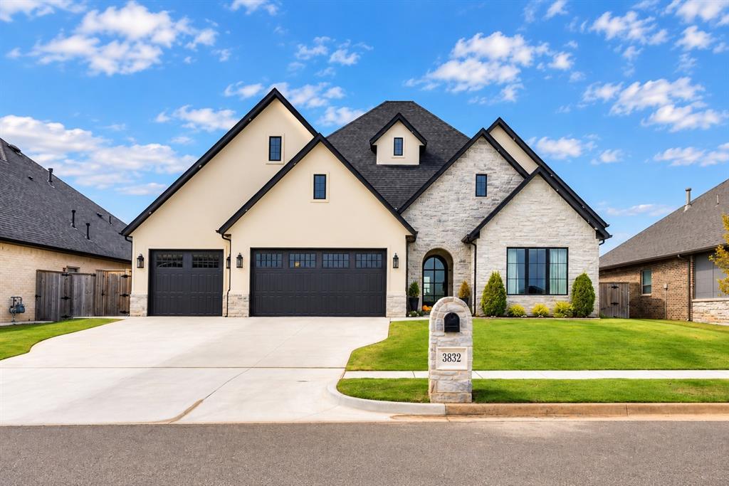 Welcome to 3832 Legacy Drive, an extraordinary custom residence in Norman's Vintage Creek. Built in 2024 by Maple Hill Designs, this 2997 sf home has a level of customization rarely found in today's market. This 4-bedroom, 3-bath home offers two living areas, an executive office, a 3-car garage and a bright, open floor plan. The impressive, spacious entry has soaring ceilings, warm wood accents and custom flooring that continues throughout the main living spaces. The kitchen has an oversized quartz island, custom cabinetry with three-stage, stained finishes, quartz backsplashes and stainless-steel Frigidaire appliances, and a custom built-in commercial refrigerator. Just beyond, a concealed butler’s pantry provides generous additional prep and storage space. Custom sliding glass doors connect the main living space to the outdoors, while French doors open to a flexible second living or formal dining. Throughout the home, elevated details include tall ceilings, reeded and grey glass accents, extensive trim work, built-in dressers, upgraded carpet and padding, porcelain tile and custom cabinetry. The primary suite has a beautifully appointed bath featuring modern finishes, double shower, and low-iron heavy glass enclosures. Motorized blackout shades, custom valances and curtains add comfort and refinement throughout the home! It has additional steel incorporated into the slab, footing and stem construction, upgraded drainage, a reverse-osmosis filtration system and storm shelter. Outside, stone and stucco architecture, black windows, retaining walls, an extensive exterior lighting package and thoughtfully designed low-maintenance landscaping create striking curb appeal. The large, covered patio is finished with a custom pine tongue-and-groove wood ceiling. From the upgraded gas fireplace and custom millwork to the cabinetry, glasswork, flooring, lighting and structural enhancements, virtually every element of this residence was intentionally selected and upgraded.