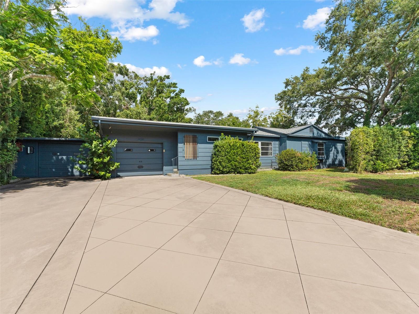 Spacious and versatile St. Petersburg home with rare 6-car garage capacity. The thoughtful layout features a large primary bedroom with office nook overlooking the oak trees and backyard patio. Living areas include a bright living room, dining area, and family room off the updated kitchen for easy entertaining. Outdoor and hobby enthusiasts will love the garage space. The house has 2 front facing garages, plus 4 detached garage spaces with alley access, ideal for cars, boats, bikes, or a workshop. Out your backdoor is a huge yard with mature landscaping that is watered by an updated irrigation system and well. Located in desirable Flood Zone X and is just minutes to Tyrone Square Mall, SunRunner Bus Stop, Pinellas Trail, dining, and the Gulf beaches. A rare opportunity to combine comfort, storage, and lifestyle in one desirable St. Pete location. This property's CRT-1 zoning will also allow for office use and multifamily redevelopment.