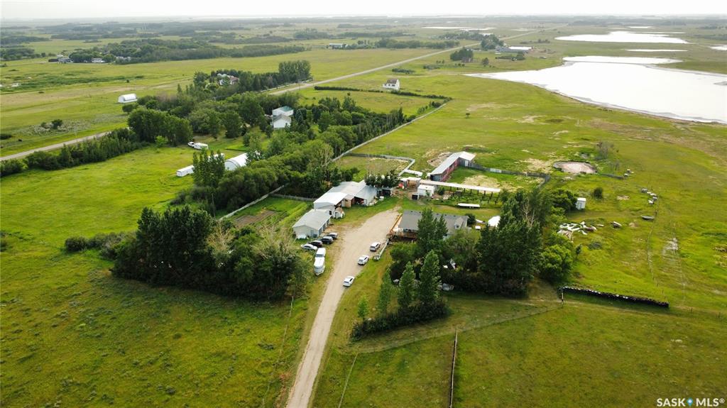 Welcome to the Deniz Acreage, an immaculately maintained hobby farm located out of Saskatoon's West Side near Grandora, SK in the R.M. of Vanscoy. With roughly 37.23 acres (10.48 of which are subdivided), and a beautiful 1,763 sqft home, this acreage is a rare find! Located under 15 minutes outside of Saskatoon, with paved roads, this acreage is an ideal balance between out of town living with accessible city amenities. This acreage features 4 bedrooms, 3 bathrooms, a walk-out basement with a paying tenant - and a beautiful wrap around deck. Upon entering this home, you will find a spacious boot room with access to a newly renovated kitchen. The open concept living area flows beautifully into the kitchen with floor to ceiling windows and glass sliding doors - this home does not shy away from natural sunlight. The upper level of this home features an oversized master bedroom with a featured skylight, a 5-piece bathroom with a gorgeous double sink, and a tiled shower/tub. The second bedroom on this floor is spacious with a large window. In addition is a 4-piece bathroom with a spacious tub. The basement of this home is a walkout basement, featuring a suite - that is currently rented out. The basement features a renovated built-in kitchen, a renovated 4-piece bathroom, and two spacious bedrooms - an ideal suite set up. The exterior of this home features a wrap-around deck, beautiful landscaping, a fire pit, a 3 car garage, spacious Quonset, 8 stall barn, an existing chicken coop, riding ring, garden, pastures, and more.  This is a hidden oasis located nearby Saskatoon, and a perfect opportunity to balance acreage living with livestock farming. This property is immaculately maintained and well-loved, ready for its new owner.
