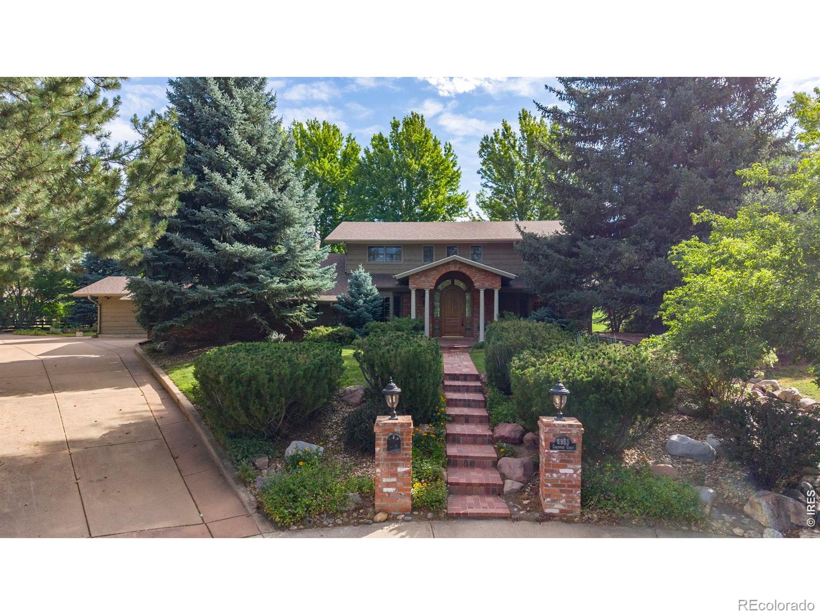 OPEN SUNDAY 1-3 PM! Perfectly situated at the end of a quiet cul-de-sac, this home is surrounded on 3 sides by mature landscaping, with the 4th/back side overlooking Boulder Country Club's Par 3 Golf Course, creating its own private oasis. On a .44-acre lot, this home offers over 5,500 SQFT of thoughtfully laid-out living space, which has been remodeled for everyday comfort and a truly one-of-a-kind first floor entertainment space. Upstairs, you'll find four spacious bedrooms, including a luxurious primary suite complete with its own private sitting room - the perfect spot for morning coffee. Rich hardwood floors flow throughout the main level, complemented by fresh paint and new carpet. The kitchen features rich granite countertops, a large island, breakfast bar and custom built-in appliances, while the great room bar makes for an exceptional gathering space. Enjoy the hearth room's morning sun, or venture into the study to discover secret stairs behind a wood panel. A hidden wine cellar and tasting room awaits you below. The arched, cave-like structure offers a fun environment for entertaining and collecting. Step outside to an expansive covered patio with sweeping golf course views. This relaxing space offers a built-in grill, tranquil water feature, and fireplace. A two-car garage with extra room for two golf carts, and a separate, attached single-car garage provide ample space for a workshop, or extra storage. The finished basement adds a spacious fifth bedroom and bath with additional flexible living space. Walking distance to Boulder Country Club, and moments from Niwot Market and Gunbarrel's favorite local shops, restaurants, and breweries - this is one you simply must experience in person.
