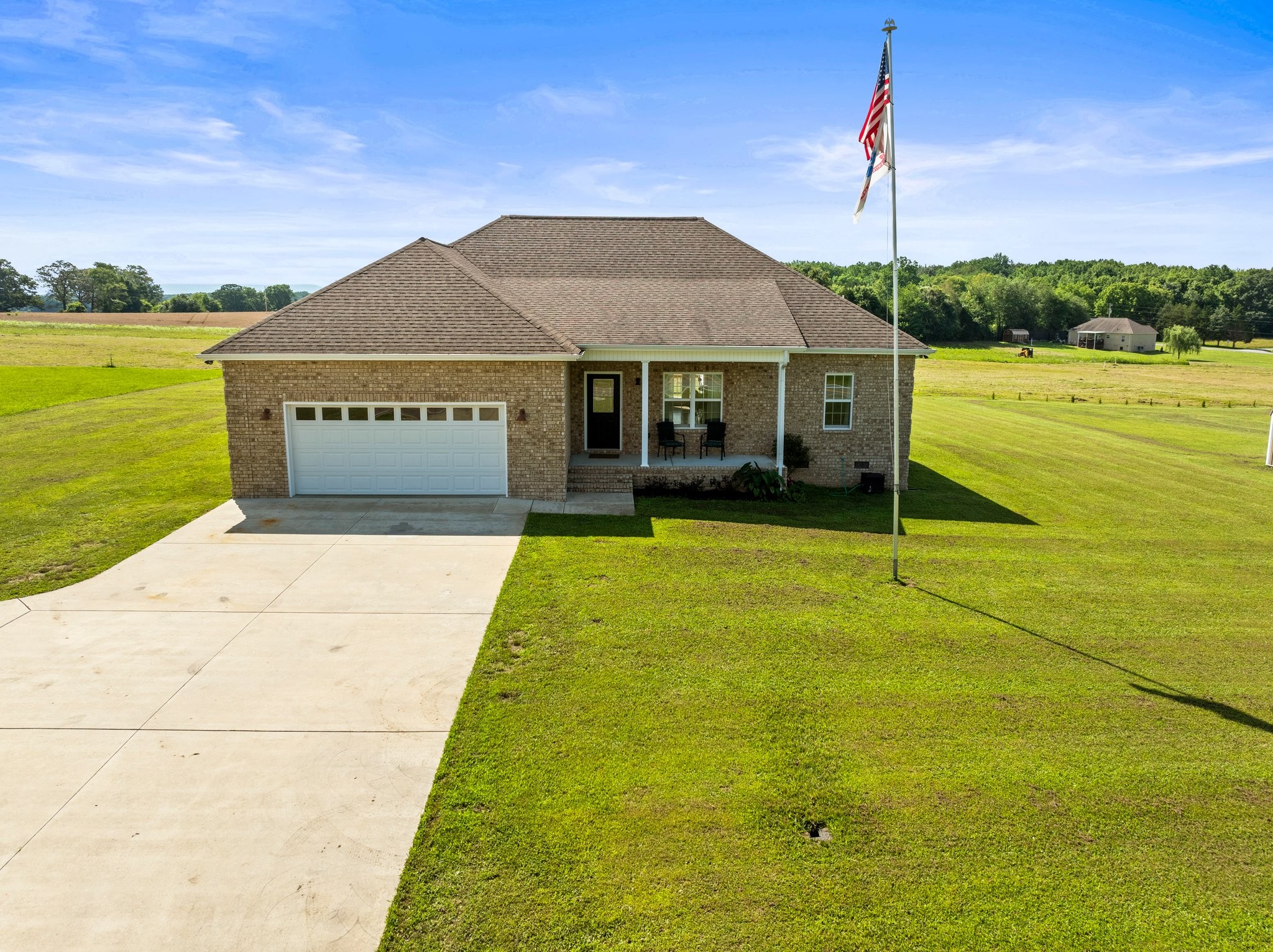 Beautiful brick home on a well traveled road. This home offers unparalleled access to everything the area has to offer, making it a convenient choice for an active lifestyle. Just minutes away from Woods Reservoir, this idyllic location is a short drive away from the cities of Winchester, Tullahoma, and Manchester with shopping/dining at it's best. Step inside this well maintained spacious 3br/2bath home featuring a stunning custom kitchen and rich real wood flooring throughout. The open-concept design makes it easy to stay connected with friends and family while preparing meals. The natural beauty of the hardwood floors creates a cozy, welcoming atmosphere. Unwind by the cozy fireplace in the living room, ideal for relaxing nights or entertaining guests. The primary suite is a true retreat, featuring a sophisticated tray ceiling that adds elegance and dimension, creating a serene space to recharge. This home includes a spacious two-car garage, providing plenty of room for vehicles, tools, and additional storage. This move-in ready home is waiting for you!  Underground dog fence. Schedule your app. today.