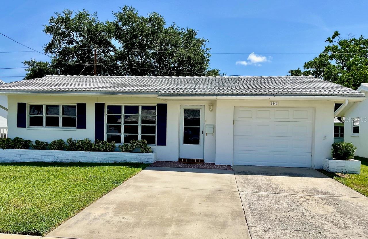 This is it! Priced to Sell! This 2 bedroom, 1 bath, 1 car garage home with 1166 sq. ft. is in the desirable 55+ community of Mainlands of Tamarac. Perfect for those ready to downsize, or a warm winter getaway home for a snowbird from up North. As you enter the home, take notice of the neutral color scheme including the tile flooring that is throughout the whole house. The open-concept living room flows to the dining room and a family room. The large family room is big enough to put in a divider and create a bonus room or an office area. There is plenty of room for entertaining family and friends. The kitchen has updated cabinets and formica countertops. Off the kitchen, is a door that opens to the laundry area and the one car garage. The front bedroom has a built-in closet and the back bedroom has a walk-in closet. The bathroom has been updated and has a step-shower. Air-conditioner was installed in 2021, new garbage disposal 2026, water heater 2024 and a water softener too. The maintenance fee includes: Clubhouse with heated pool, water, sewer, trash, internet, cable, exterior painting, lawn, and roof. Mainlands is a golf-cart community. This driveway will accommodate 2 vehicles; one could be your golf cart. Mainlands Unit 3 has lots of social activities for you to enjoy such as; dances, water aerobics, card parties, French toast breakfast, bingo, and shuffleboard. This home is conveniently located just minutes from Mayor Park, Mainlands Public Golf Course, airports and downtown St. Petersburg. Your place in the sun is waiting for you. Call to schedule your private showing.
