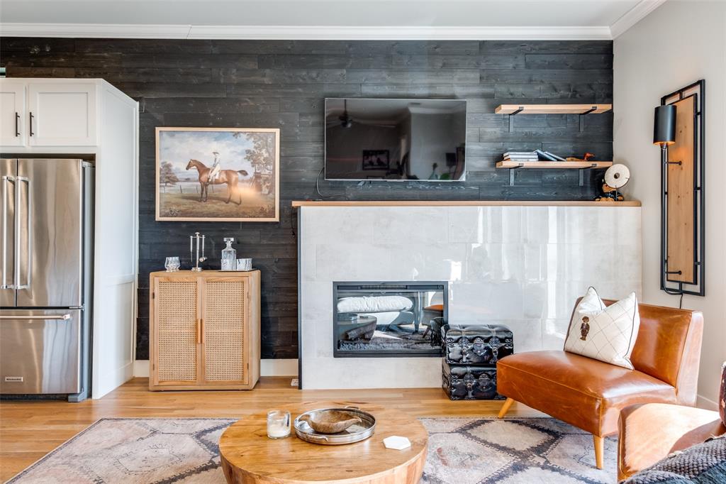 This contemporary end-unit townhome offers a private first floor guest suite complete with an office space that can be used as a second living area. The second story greets guests and homeowners alike with abundant natural light and modern finishes throughout. The open concept kitchen includes an oversized quartz island, gas cooktop, Kitchen Aid appliance, extensive cabinet space, and a walk-in pantry. Off of the kitchen is an oversized primary bedroom, designed thoughtfully with roller shades and craft wallpaper to create a warm and inviting respite. The top floor opens to a turfed rooftop terrace, providing a space for relaxing or hosting while enjoying skyline views. The location provides convenient access to Downtown Dallas, Lower Greenville, White Rock Lake, and nearby dining and retail.