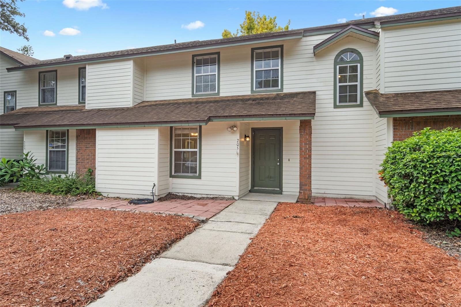Welcome to the quiet community of Deer Run and your own lakeside living retreat!  This spacious 2-bedroom, 2-bath waterfront townhouse features 1,166 square feet of freshly painted interiors, soaring ceilings, and abundant natural light, and of course gorgeous views out over the water.

The main living area features a dramatic vaulted ceiling with exposed beam accents and a wall of sliding glass doors that frame beautiful views of the water. Step outside to your private patio and enjoy peaceful mornings or relaxing evenings by the lake.

The kitchen has a modern edge with sleek dark cabinetry, solid countertops, and a convenient pass-through bar that opens to the dining and living spaces—perfect for entertaining. A downstairs bedroom provides flexibility for guests or a home office, while the upstairs primary suite offers wood-look flooring, a huge walk-in closet, and direct access to an ensuite bath.

Additional highlights include an inside laundry area, additional storage room off of the rear patio, and low-maintenance tile flooring throughout the main living spaces. The community is tucked away in a serene setting, yet just minutes from shopping, dining, major roadways, and all that Casselberry and the surrounding area have to offer, all located within the A-rated Lake Howell HS District.

Whether you’re looking for a full-time residence or a low-maintenance retreat with water views, this townhouse delivers a rare combination of tranquility and convenience.

Sellers have this priced to move, so call today for your private showing.