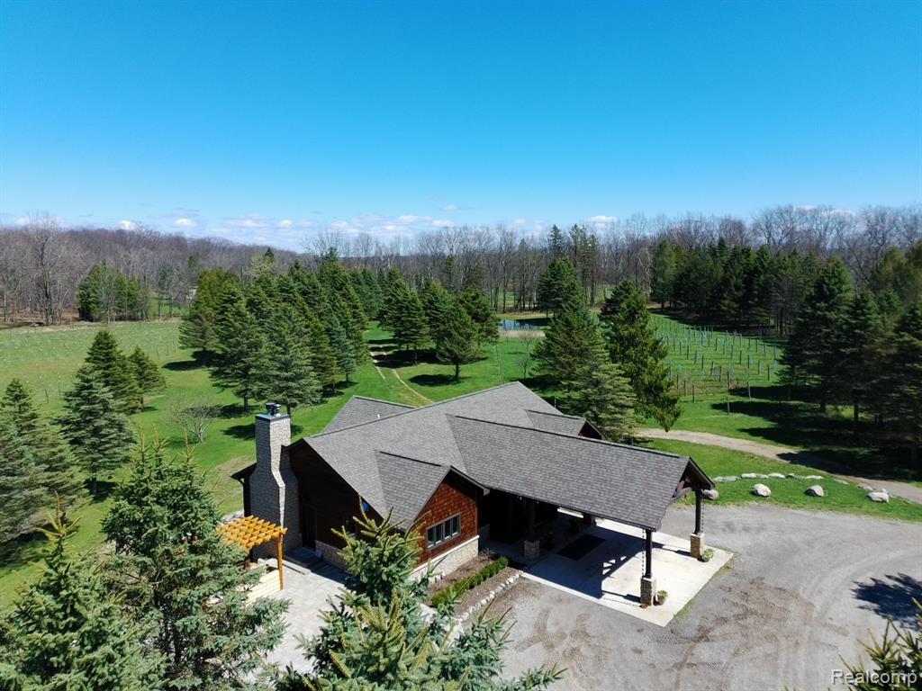 82 Acres of pure serenity! This home is located towards the back of the property giving it total seclusion from the world. She was built in 2019 and finished in 2020 it is a true master price inside. Solid Cherry flooring throughout the main floor, towing ceilings and lined with windows bringing the outdoors inside. Large chefs kitchen with a 7 burner gas range with double ovens, full upright Refrigerator along with a 2 draw cabinet prep cook refrigerator. Built in Microwave and Coffee Maker all lined with top of the line custom cabinets. The primary suite is amazing check out that copper soaking tub along with the walk-in steam shower, just waiting for you to melt away your stressful day! The lower level fully finished walkout basement with heated floors, has a full copper wet bar with all the amenities one would expect. 2 more bedrooms another full bathroom, a 2nd laundry room, living room & rec room with pool table & wood stove to gather around. The outdoor entertainment veranda is plumbed for a full kitchen just needs cabinets and countertops, the wood fireplace will help take the chill off. There also is a greenhouse, 30x40 Pole Barn / garage for your equipment insulated & heated, even a she shed or man cave that is also in heated and air conditioned.  I think you will find it a 'retreat from the everyday grind'.