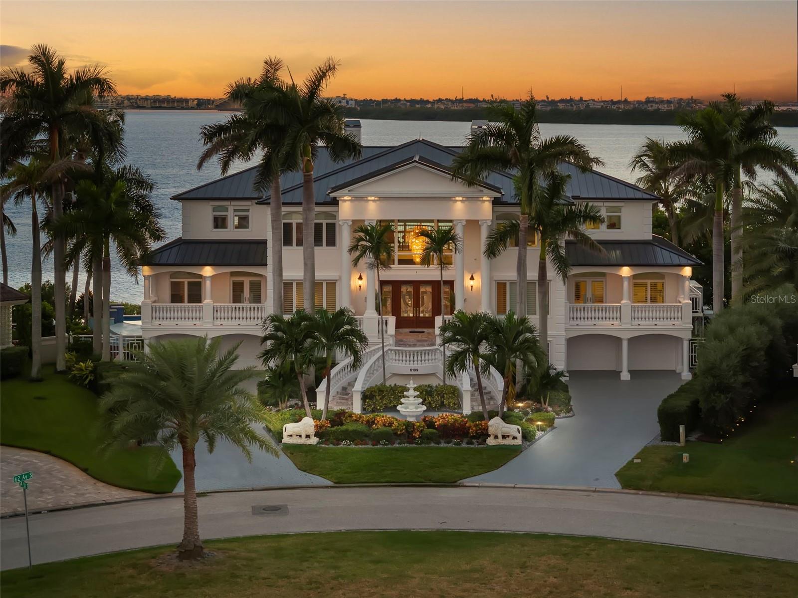 BACK ON MARKET due to buyer’s inability to close—no fault of the property.  Commanding an extraordinary point-lot position with 135 feet of waterfront on on over a 1/2 acre, this exceptional Bayway Isles estate delivers sweeping open-water views, spectacular sunsets and a level of privacy and boating access that is increasingly rare in St. Petersburg.Set within prestigious, guard-gated Bayway Isles, the 6100+square-foot residence combines timeless architecture, substantial recent improvements and expansive indoor-outdoor living, with approximately 3,800 square feet of balconies (over 13,600 SF under roof) overlooking the water. This 5-bedroom, 5.5-bath residence also features a private elevator servicing all levels.Recent substantial improvements include a brand-new charcoal-colored metal roof with lifetime warranty, freshly painted exterior and an updated kitchen featuring modern white cabinetry and top-of-the-line stainless steel appliances.The main living level showcases marble flooring, an expansive waterfront great room, custom wet bar, theater screen and formal waterfront dining room. Also on this level are a generous guest suite with en-suite bath, powder room, walk-in pantry and private office with custom built-ins.Upstairs, four spacious bedroom suites are arranged in a desirable split plan, allowing the primary suite to occupy its own private wing. The luxurious primary retreat captures expansive water views and features plantation shutters, a custom walk-in closet with center island and a beautifully remodeled bath with dual vanities, Jacuzzi tub, walk-in shower and abundant cabinetry. Refinished hardwood floors extend throughout the upper level.Exceptional all-block construction includes 6-inch poured concrete floors, hurricane protection, a new whole-house generator and split four-car garage with epoxy flooring. Approximately 1,600 additional square feet of bonus and storage space provides tremendous flexibility, along with a private home gym.Outside, enjoy a beautifully refurbished infinity-edge pool and expansive deck surrounded by lush tropical landscaping and programmable lighting. The brand-new dock with 16,000-pound boat lift, 135 feet of waterfront and immediate access to Tampa Bay and the Gulf beyond creates an exceptional setup for boating enthusiasts.Ideally located approximately 10 minutes from vibrant Downtown St. Petersburg and 30 minutes from Tampa, this extraordinary Bayway Isles estate offers a rare combination of luxury, privacy, boating and location. Recent wind mitigation and 4-point inspection reports are available, supporting more favorable insurance options.