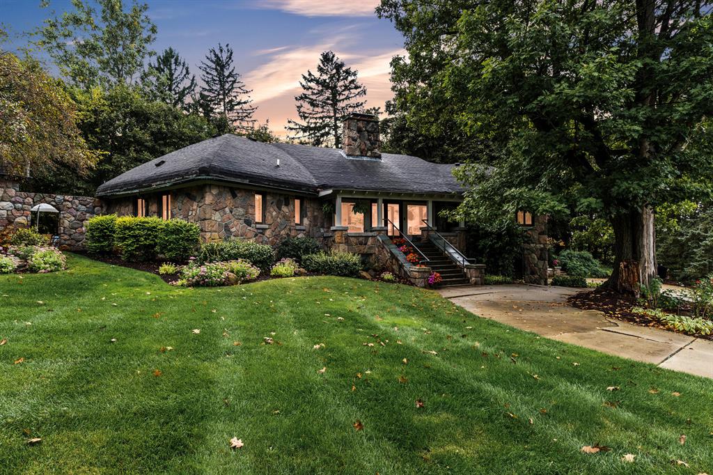Crafted from enduring stone and steeped in history, this extraordinary 1920s residence was originally built as the clubhouse for a private nine-hole golf course. Nearly a century later, it remains one of the area's most distinctive properties--an elegant home that captures the character of its past while offering the comfort and convenience of modern living. From the moment you arrive, the stone facade and beautifully landscaped grounds create a sense of permanence and retreat. The home's historic architecture is complemented by thoughtful updates, making it as practical as it is captivating. Step inside to discover soaring ceilings, rich woodwork, and a dramatic stone fireplace that anchors the grand living room. Expansive windows fill the home with natural light, and the floorplan flows gracefully from the formal dining room to the bright sunroom and covered porch--perfect for gathering, entertaining, or simply unwinding. The primary suite offers a true sanctuary, complete with anewly designed spa bath featuring heated floors and luxe finishes. Additional bedrooms provide flexibility for family, guests, or a home office. Every room carries a sense of warmth and character, while updated mechanicals throughout provide peace of mind. Yet the highlight of the property lies just beyond the patio: an exceptional pool house designed for year-round enjoyment. This private retreat features a full-sized indoor swimming pool, hot tub, full bath, and generous space to entertain or escape in any season. Whether hosting lively gatherings with friends or enjoying a quiet evening by the water, the pool house is a showpiece that sets this home apart. Set on an oversized lot, the property also includes an attached two-car garage with EV charging, ample storage, and convenient highway access. Just a mile from Whitmore Lake, it offers the rare balance of privacy and proximityclose to everyday amenities, yet tucked away in a setting that feels like a world of its own. Stone homes of this scale, character, and history rarely come t