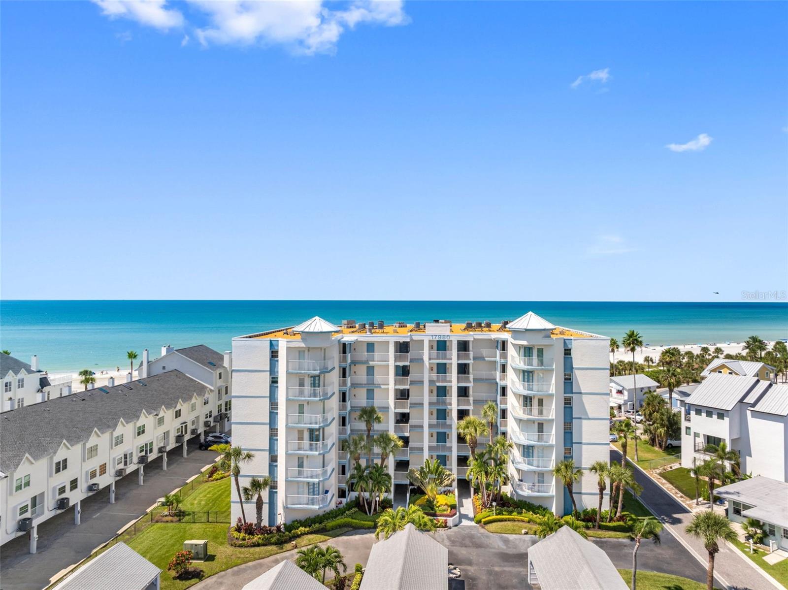 Excellent gulf-front opportunity! Desirable southwest corner unit in the well-known Lighthouse Pointe. Soaring blue and green views as far as the eye can see from this fourth-floor southwest corner direct beachfront unit! Updated two-bedroom, two-bath condominium with three balconies features porcelain plank floors, white shiplap walls, updated modern insert fireplace and plantation shutters. Kitchen features Kraft-Maid soft-close cabinetry, Silestone quartz, glass tile backsplash, stainless appliances, closet pantry, breakfast bar and Gulf views. Open-concept living and dining corner location with access to gulf-front balcony offering incredible views. Primary en suite with huge walk-in closet and balcony with Gulf views. En-suite bath updated with walk-in shower, custom Kraft-Maid cabinetry and quartz. Sunrises in second oversized bedroom accommodate queen beds, walk-in closet, and has French doors to balcony with Intracoastal water views. Central second bath with updated marble-style tile walk-in shower, custom cabinetry and quartz.  This 1,405-square-foot unit lives large with foyer, extra hall closet, laundry closet with washer and dryer, and personal storage closet off your balcony. Electric storm shutters protect all the sliding glass doors and the gulf-front balcony’s storm shutters are on the perimeter, so there is no need to pull in patio furniture due to weather. Unit comes with one assigned carport parking and plenty of guest parking.  Lighthouse Pointe is a boutique building with only 36 units on 200 feet of prime beach/Gulf frontage and it is the widest beach south of Sand Key Park. Lighthouse Pointe sits on 2.5 acres and is impressive with its manicured lawn on the Gulf side offering lush landscaping that surrounds the pool area.  They don't make them like this anymore. Building offers secured lobby, poolside restroom, designated landscaped pet walk, and community storage for your kayak, paddleboard or bicycle. In front of Lighthouse Pointe is a replica of a U.S. lighthouse, which has made this development an iconic landmark along the Redington beaches.