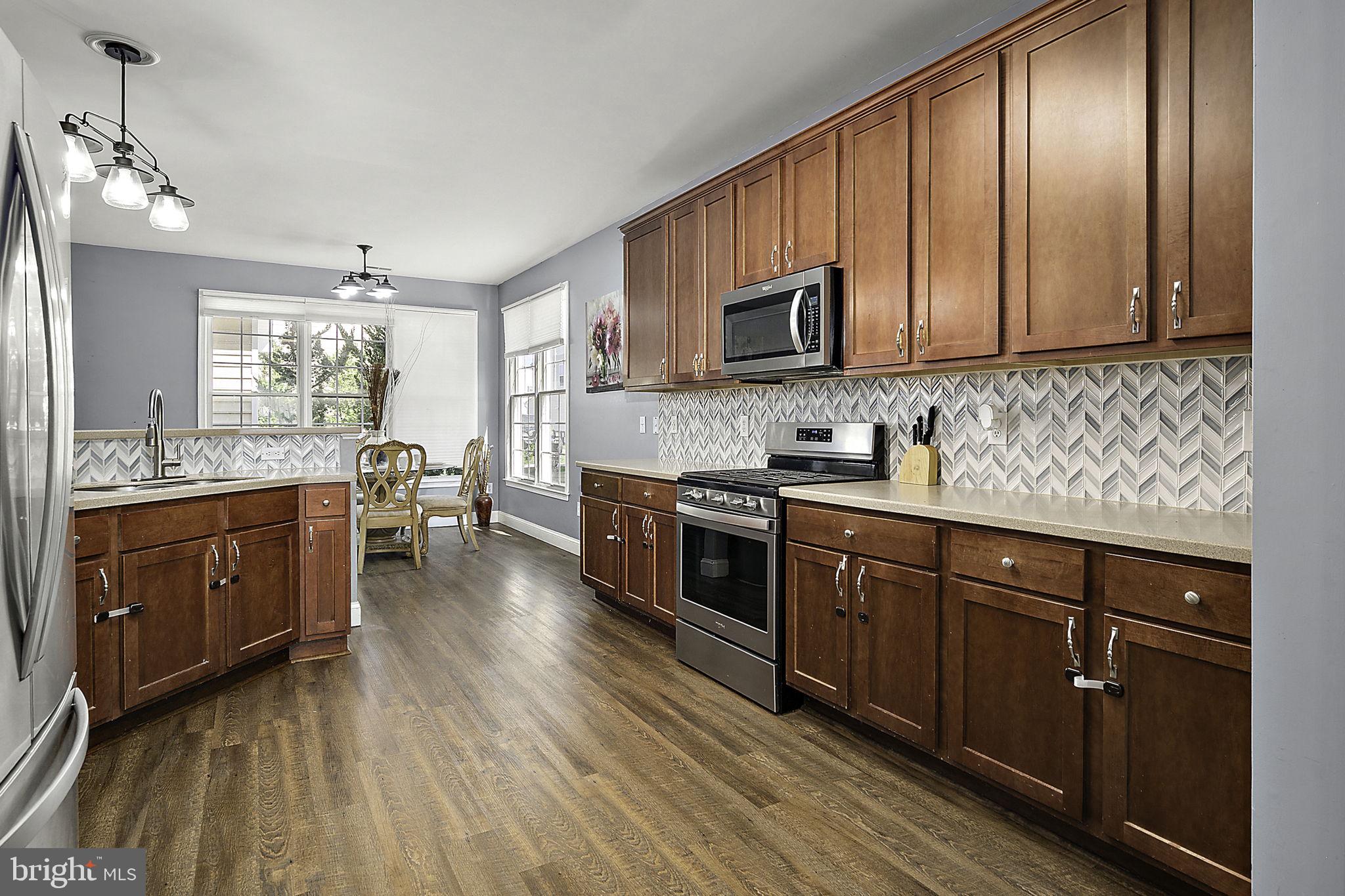 Price Reduction at 12167 Snug Harbour Rd, Berlin, MD – Tucked within the sought-after community of The Landings at Bayside, this beautifully maintained home offers spacious living, resort-style amenities, and unbeatable access to everything the Eastern Shore has to offer. A welcoming front porch with a cozy sitting area sets the tone, while the rear yard features a private patio—perfect for grilling and outdoor entertaining. Inside, the first floor boasts a formal living room and dining room, an open-concept kitchen with breakfast area, a family room with fireplace, and a convenient guest half bath. The second level includes a luxurious primary suite with soaking tub, double vanity, separate shower, plus three additional bedrooms—and a full hall bath. The third floor provides a large bonus space ideal for a fifth bedroom, playroom, game room, or guest suite, complete with a full bathroom. Enjoy the convenience of a detached garage and direct access to a community pathway that leads just a short distance to the pool and clubhouse. With low taxes, affordable HOA fees, and short-term rentals allowed, this home is perfect as a primary residence, vacation getaway, or investment property. The Landings at Bayside offers an exceptional lifestyle with indoor and outdoor heated pools, fitness center, game room, tennis and basketball courts, crabbing pier, stocked fishing pond, kayak launch, nature trails, tot playground, and two community docks with breathtaking bay views. Lawn care and trash service are included, making life here as easy as it is enjoyable.