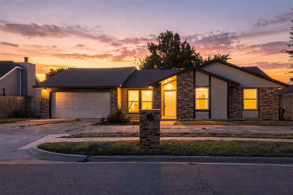 Welcome Home! This spacious single-story home offers a functional layout with plenty of character and recent interior updates. Step inside to find new flooring and carpet, a large living room with vaulted ceilings, exposed wood beams, built-in shelving, and a floor-to-ceiling brick fireplace that serves as the focal point of the space. The kitchen features granite countertops, abundant cabinetry and storage, a tiled backsplash, breakfast bar, and an adjoining dining area. The home also offers updated bathrooms with granite countertops, generously sized bedrooms, and a primary suite with a walk-in closet. Just off the kitchen, the enclosed sunroom provides flexible additional space for relaxing, entertaining, a home office, or playroom. Outside, enjoy a large concrete patio and fenced backyard with mature greenery. With spacious rooms, great storage, and a mix of updates and original character, this home is ready for its next owner. A new roof and garage door will be installed before closing.