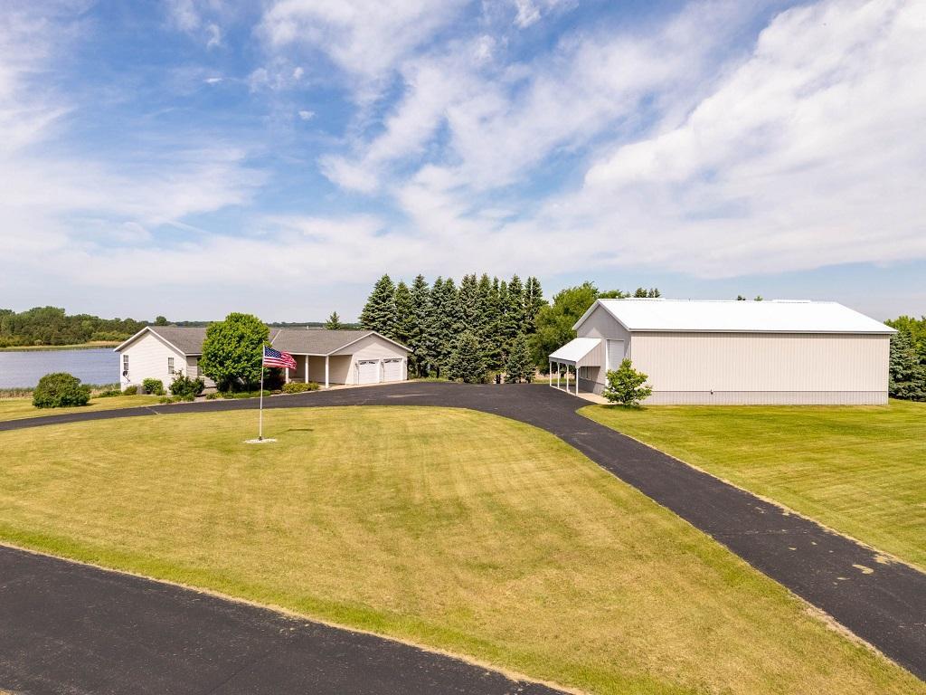 Discover the perfect blend of space, privacy and functionality on this exceptional 35+ acre property.  Featuring over 3,600 square feet of living space, this well-appointed home offers three bedrooms and two bathrooms designed for comfortable country living.  Take in the incredible view overlooking a picturesque pond, where abundant wildlife creates a peaceful and scenic backdrop year-round.  Whether you're enjoying your morning coffee or relaxing at sunset, the natural beauty surrounding this property is truly unmatched.  A standout feature is the impressive 40' x 60' shed complete with a shop area, a bathroom and three overhead doors, providing ample space for equipment, hobbies and storage.  High-speed fiber internet service ensures you can stay connected while enjoying the tranquility of rural living.  With a rare combination of acreage, stunning views, abundant wildlife and exceptional outbuilding space, this property offers endless opportunities to live work and play in a beautiful country setting.  Sold in As Is Condition