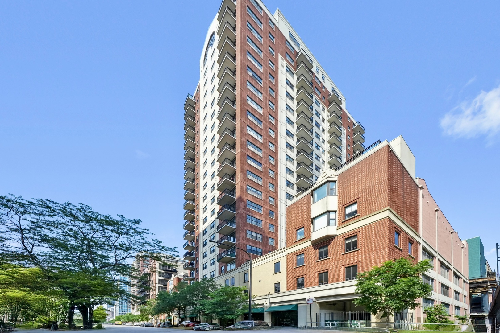 Enjoy the best of both worlds with this spacious townhome-style residence offering all the amenities and security of a high-rise building. With 3 bedrooms, 2.5 baths, and two private outdoor spaces, this home lives like a single-family, yet benefits from full-service building perks.  Enter through the beautifully landscaped fourth-floor courtyard into a welcoming freshly tiled foyer with seating space and two oversized closets-perfect for coats and seasonal storage. The main level features dark oak hardwood floors and a fully renovated kitchen designed for both function and style. Highlights include quartz countertops, 48" birch cabinetry, textured tile backsplash, premium appliances (Thermador, Bosch, and more), chic pendant lighting, and a large island with butcher block top, built-in wine fridge, and custom eat-in dining table. The open-concept living room easily accommodates a large sectional and flows seamlessly onto the private patio, ideal for indoor-outdoor entertaining and grilling. Two essential updates add modern convenience: a main-level powder room and a walk-in pantry offering additional storage. Upstairs, the expansive primary suite fits a king bed with room for a sitting area and features a professionally organized walk-in closet and a brand-new en-suite bath. The spa-quality bathroom is equipped with a double quartz vanity, designer fixtures, custom lighting, fresh tile, and a curbless walk-in rain shower with integrated niche and seamless floor drain. A second spacious bedroom, updated guest bath, and full walk-in laundry room complete this level. On the top floor, you'll find new luxury vinyl plank flooring, and a versatile flex space-perfect as a third bedroom, home office, family room, or a combination of all three. This level opens to a sunny and supersized, south-facing rooftop deck for relaxing or entertaining outdoors. Unmatched value with HOA dues that cover nearly everything except electricity. What's included? Exterior maintenance (facade, roof, etc.), professional landscaping, water, gas, cable, internet, building insurance, 24-hour door staff, elevators, a fully equipped fitness center, meeting room, bike storage, large storage lockers, and on-site management and maintenance. Perfectly located in a well-maintained building with all the creature comforts and a highly functional layout- this is city living without compromise! One deeded garage parking space available for $25K additionally.