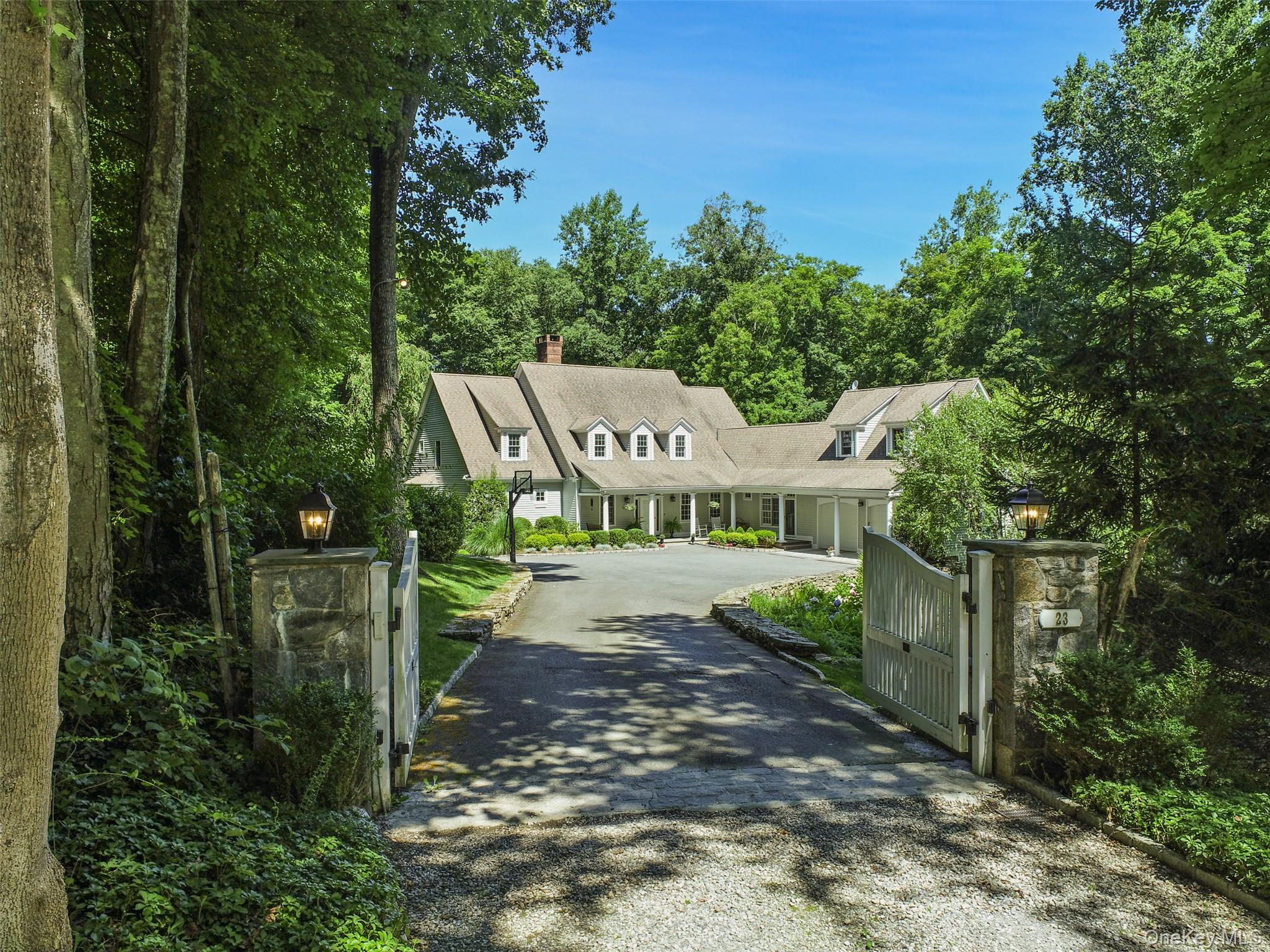 SOPHISTICATED FARMHOUSE - Impeccably appointed and sophisticated Country Farmhouse. Stunning spaces with beautifully proportioned rooms, high ceilings and virtual window walls to capture natural light and views.  Neutral walls complement hardwood floors in a deep dark stain. Open floorplan allows for easy entertaining and everyday family living. Gracious Entrance Hall with formal Powder Room. Sun-filled Living Room with soaring ceiling fireplace and doors to spacious rear deck. Formal Dining Room. Open concept Kitchen with new appliances & counters; breakfast area and Family Room with fireplace. Private Office for working remotely. First Floor Primary Suite with Dressing Room and luxurious, new Bath with radiant heat, soaking tub and frameless glass shower. Three additional Bedrooms plus second floor Sitting/Computer Room.  All Five Bathrooms have been recently renovated & updated.  Fully finished walkout Lower level with Recreation Room with fireplace, Gym and Wine Cellar.  Located in Rock Rim Ponds, over seven fenced acres with gently rolling lawns, age-old trees and mature shrubs. Perfect privacy at the end of a cul-de-sac abutting acres of conservation lands. A fabulous offering!