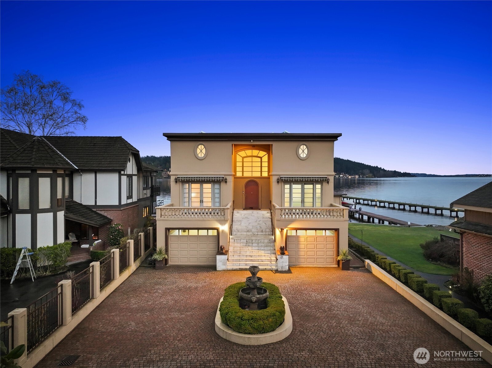 Stunning Lake Washington waterfront retreat w/57 feet of prime no-bank frontage in the heart of Lake Forest Park’s highly sought-after Sheridan Beach. Set on a level 14,169 square foot lot, this private, gated 4 bedroom, 4.5 bath Mediterranean-style residence enjoys expansive southeast-facing views across Lake WA to the Cascade Mountains, Inglewood Golf Club & Arrowhead Point, along w/sweeping vistas toward the north end of the lake, Mt Rainier, Magnuson Park & endless sunrises. Constructed in 1994 & built to a strong standard of quality, this elegant 4,930 SF home offers light-filled living spaces w/cathedral ceilings & refined architectural detail. Luxurious chef’s kitchen w/high-end Viking, Bosch & Gaggenau appliances, custom cabinets & striking barrel ceiling. 2 spacious primary bedrooms w/walk-in closets & spa-like bathrooms. Ample lower-level w/2 add'l bedrooms, 2nd kitchen & family room. Dazzling deck & patio, hot tub & level lawn. The exceptional outdoor setting also includes the property’s right to access the 110-foot shared dock on the adjacent SW property via recorded easement. Gated property w/2 separate oversized one-car garages & off-street parking. Perfectly located on a quiet residential lane, the home is within walking distance to Lake Forest Park Town Center & the Burke-Gilman Trail & just 10–15 mins to U-Village, Magnuson Park & the rest of Seattle. An exceptional opportunity to own a stunning Lake Washington waterfront home!