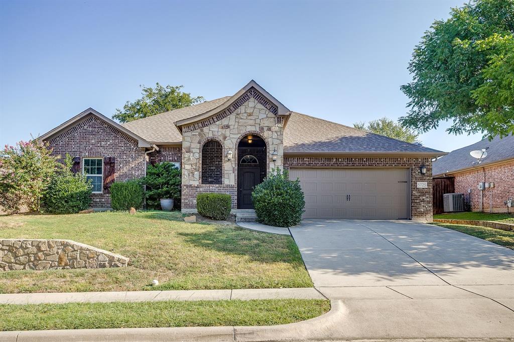 Beautiful brick and stone home in the Eagle Mountain - Saginaw school district. Arched entry leads to covered front porch. Tandem 3 car garage. Split bedroom arrangement. Large open floor plan with lots of room and tall ceilings. Privacy fenced backyard. Split bedroom arrangement with master bedroom in the rear. Tall ceilings and ceiling fans in each room. Big master with ensuite bath. Walk in tiled shower and separate garden tub. Nice walk in closet too. Double vanity. Walking distance to Boo Ray's! Easy access to Marine Creek Lake. Close to shopping and restaurants.
