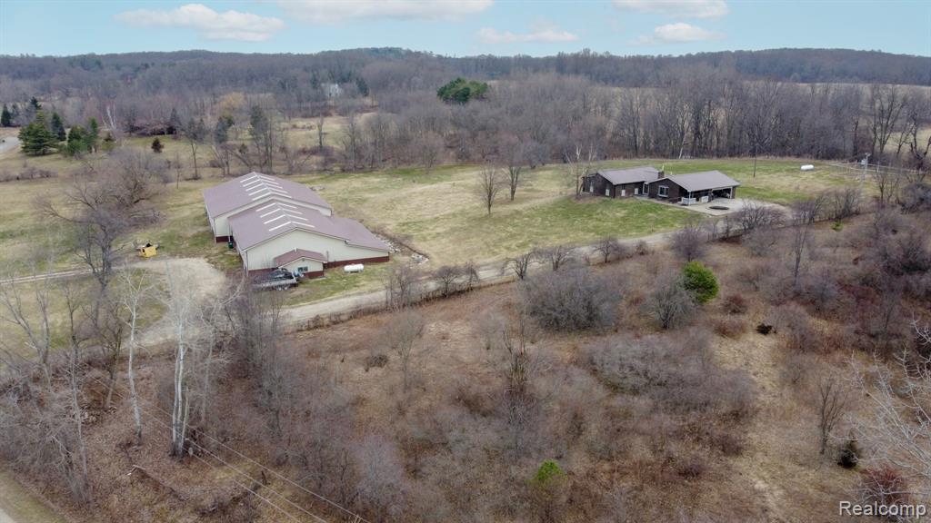 This is a rare opportunity to own a 3 bedroom, 3 bath, ranch home that sits atop 7.5 rolling acres in Oxford Township, bordering Ortonville. There is so much privacy, you will never know that you are in Oakland County and close to everything. You can unwind in the living room offering a fireplace with a wood burning stove insert, or enjoy the garden view from the family room after creating a meal in your updated kitchen with an island and modern appliances. The finished lower level provides another living area with an open space, a 3/4 bath, and two more multi-purpose rooms with brand new carpet! But the real SHOWSTOPPER here is the outbuilding featuring over 13,000 square feet of possibilities! It can easily be converted back to the equestrian facility and indoor arena that previously existed, or you can utilize all of the updates turning this space into three profitable businesses. All of this is priced for a quick sale! So that nobody misses out on an opportunity to view this home, we have scheduled open houses for Saturday, March 28th from 12-4 and Sunday, March 29th from 2-4.