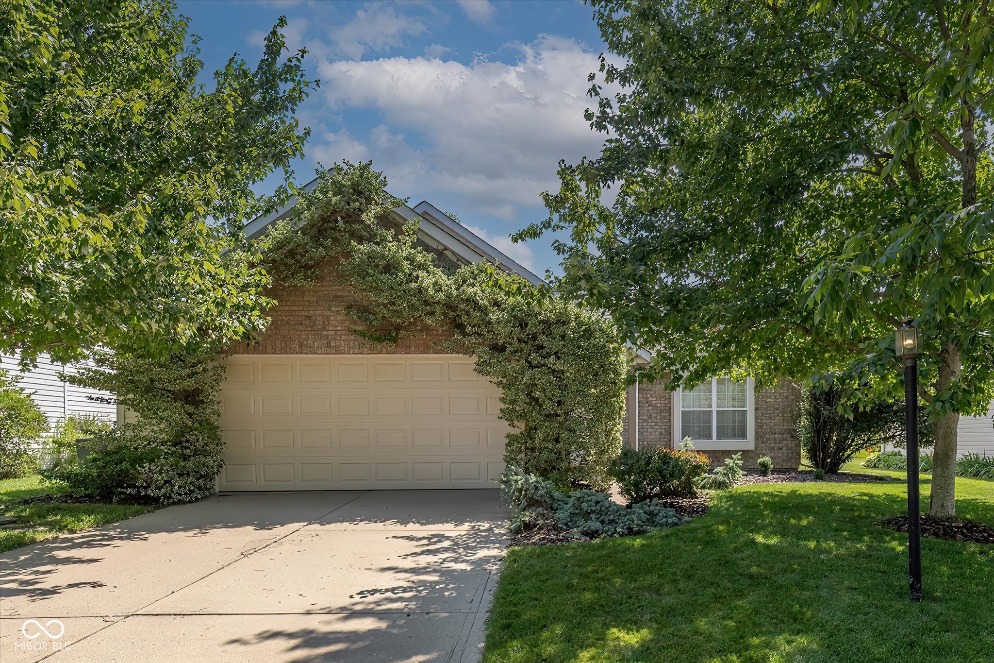 Fishers 3 bed 2 bath RANCH home-Proudly offered by the ORIGINAL OWNER, this home has been lovingly maintained and meticulously cared for since day one. While a buyer may choose to make cosmetic updates to match their personal style, the home has been exceptionally maintained, making it an incredible opportunity to build instant equity at an affordable price!  Discover fresh paint throughout, creating a bright and welcoming space that's truly move-in ready. Cozy up around the gas fireplace, and enjoy the peace of mind that comes with major mechanical updates, including a new A/C (2024), water heater (2022), furnace with whole-home humidifier, and a Kinetico reverse osmosis system. All appliances-including the washer and dryer-will remain with the home. The seller is also offering a HOME WARRANTY for added peace of mind. The backyard is your own private retreat. The fully fenced rear yard features a durable powder-coated steel fence with three gates for convenient access from either side of the home and the rear of the property. Also, the fenced area is accessible through the back patio door, or the service entrance in the garage...muddy paws are of no concern.  An oversized paver patio, attractive stone walkway, and beautiful, mature landscaping create an inviting outdoor living space, while the natural hillside beyond the backyard provides additional privacy and a peaceful backdrop. Rain barrels also convey with the property for eco-conscious gardening. The garage offers extra functionality with a bump-out storage area, service entrance, and a smart app-controlled garage door, which is also insulated, adding everyday convenience. Located just minutes from Fishers' outstanding parks, shopping, restaurants, entertainment, community center and commuter routes, this home offers the perfect combination of location and value. Homes that have been well-cared for this well cared for by their original owner don't come along often. Bring your decor ideas and MAKE IT YOURS!