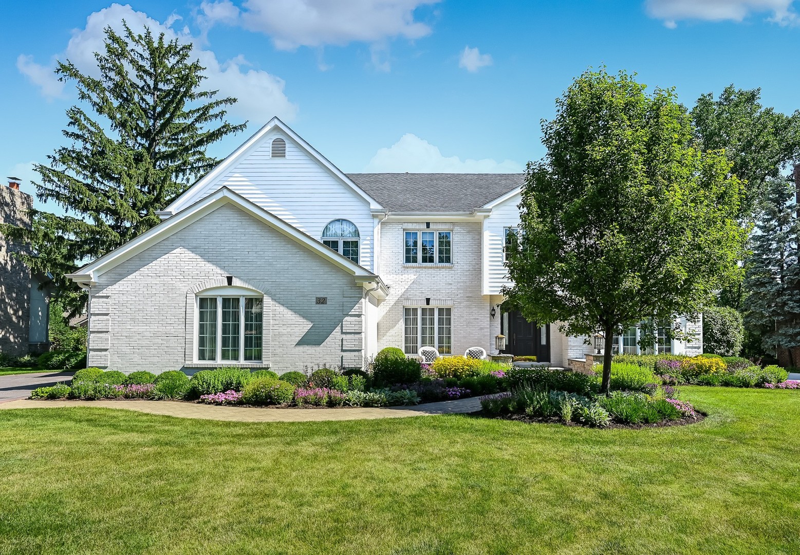 From the moment you pull into the custom stamped driveway, it's clear this property has been maintained with an uncompromising eye for detail. This location offers the perfect balance of convenience and prestige, situated just minutes from premier shopping, major highways, and the highly regarded Elm Elementary, Hinsdale Middle, and Hinsdale Central schools. Tucked away on a peaceful cul-de-sac, the home greets you with professional landscaping by Coventry Gardeners and a charming front courtyard. This is a true "turn-key" opportunity where all the heavy lifting has already been done: a new roof and gutters (2022), exterior painted (2026), a new 75-gallon water heater (2024), and updated sprinkler mechanics (2025). Even the three-car garage has been elevated with new doors (2025) and a fresh Comer & Cross epoxy floor (2026). Inside, the home feels airy and bright, thanks to a freshly painted interior, new carpeting, and updated light fixtures throughout. The layout flows beautifully into the formal living room, featuring a cozy fireplace, and an elegant dining room designed for effortless entertaining. The heart of the home is a dramatic two-story family room anchored by a stately fireplace and a wet bar, perfect for hosting. The kitchen features custom soft-close cabinetry, a center island, and a sunny breakfast nook that opens to the patio. For those working from home, the tucked-away office with built-in bookshelves offers a sophisticated retreat. The second level is highlighted by a generously sized primary suite, offering a comfortable and private space to unwind. The spa-like primary bath has been thoughtfully updated (2024) with quartz countertops, a deep soaking tub, and a separate shower featuring premium Hansgrohe fixtures. Three additional bedrooms provide plenty of space, including one with a private ensuite and another with unique loft access. The lower level expands your living space significantly, offering a recreation room, game area, play room/flex space, and a dedicated bar for weekend gatherings. Outside, the backyard serves as a private oasis with a paver patio, brick knee wall, and a built-in grill and cooktop. This is a rare chance to move right in and start enjoying a sophisticated lifestyle in a premier location.