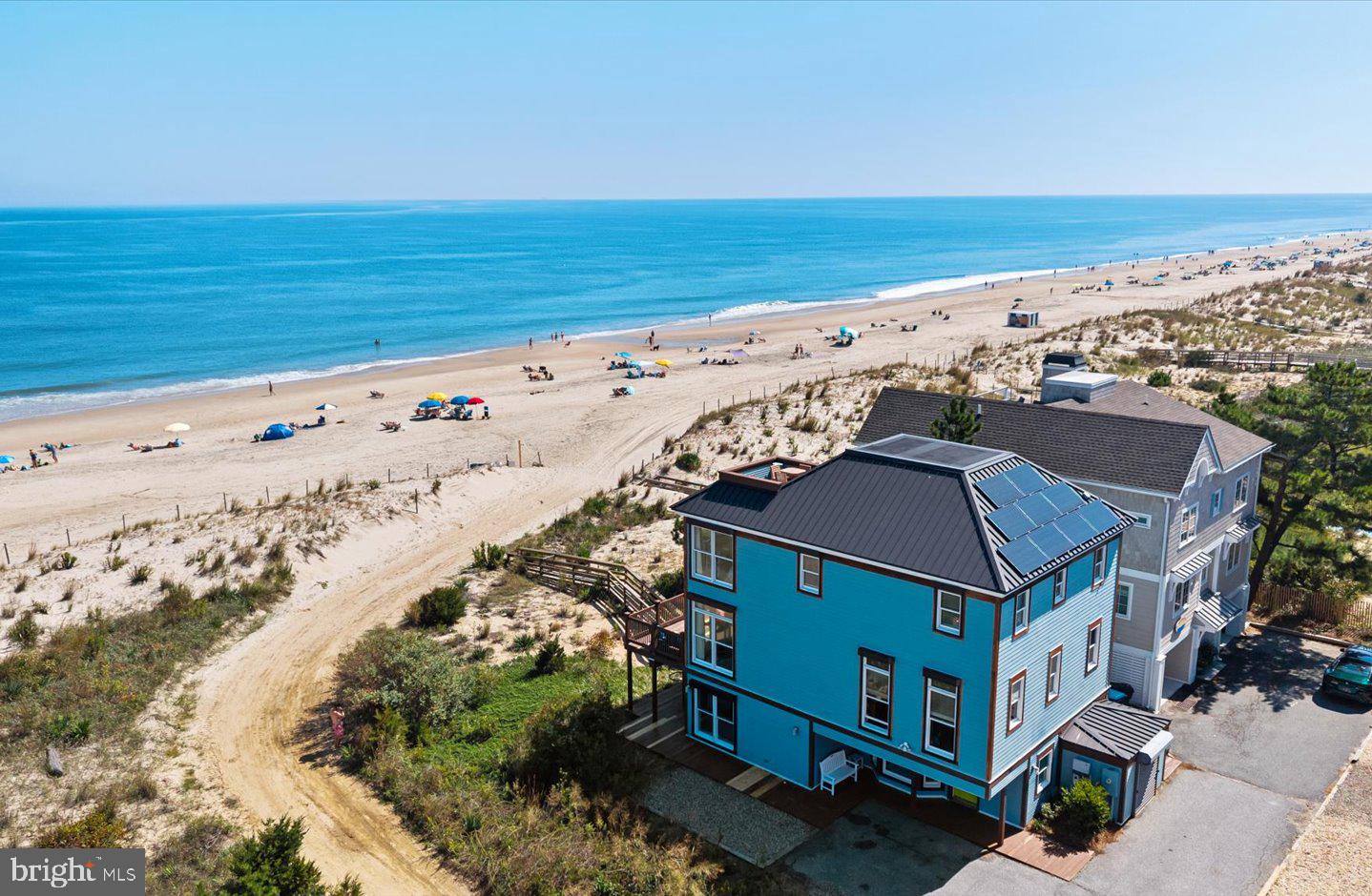 Rare oceanfront opportunity in Rehoboth by the Sea. Discover unparalleled coastal living at 2 Chicago Street, an oceanfront retreat in the highly coveted community of Rehoboth by the Sea on the north end of Dewey Beach. This exceptional 6-bedroom, 5.5-bath home offers sweeping panoramic views from nearly every room, with a private dune crossover that leads directly to the wide, sandy beach. The first level welcomes you with a bright entry foyer, two bedrooms (including a flexible oceanfront space ideal for a den, exercise room, or guest suite), two full baths, and a convenient laundry room. Upstairs, the recently updated kitchen shines with quartz counters, stainless steel appliances, and custom cabinetry, seamlessly flowing into the dining and living areas—all framed by walls of windows showcasing endless ocean vistas. Step outside to the expansive oceanfront deck, perfect for sunrises, gatherings, and salty breezes. A private office with sweeping north-facing views completes this level. On the third floor, you’ll find four additional bedrooms and three full baths, including the oceanfront primary suite with its own balcony for uninterrupted sunrise views. The rooftop deck crowns the home, offering a bird’s-eye view of the coastline—an unforgettable setting for stargazing or enjoying fireworks on July 4th. Rehoboth by the Sea is one of the Delaware coast’s most sought-after neighborhoods, known for its wide beaches, relaxed atmosphere, and close proximity to both Rehoboth and Dewey Beach attractions. Currently, 2 Chicago Street stands as the only oceanfront property available in either community—making this a truly rare opportunity to own a piece of coastal paradise.