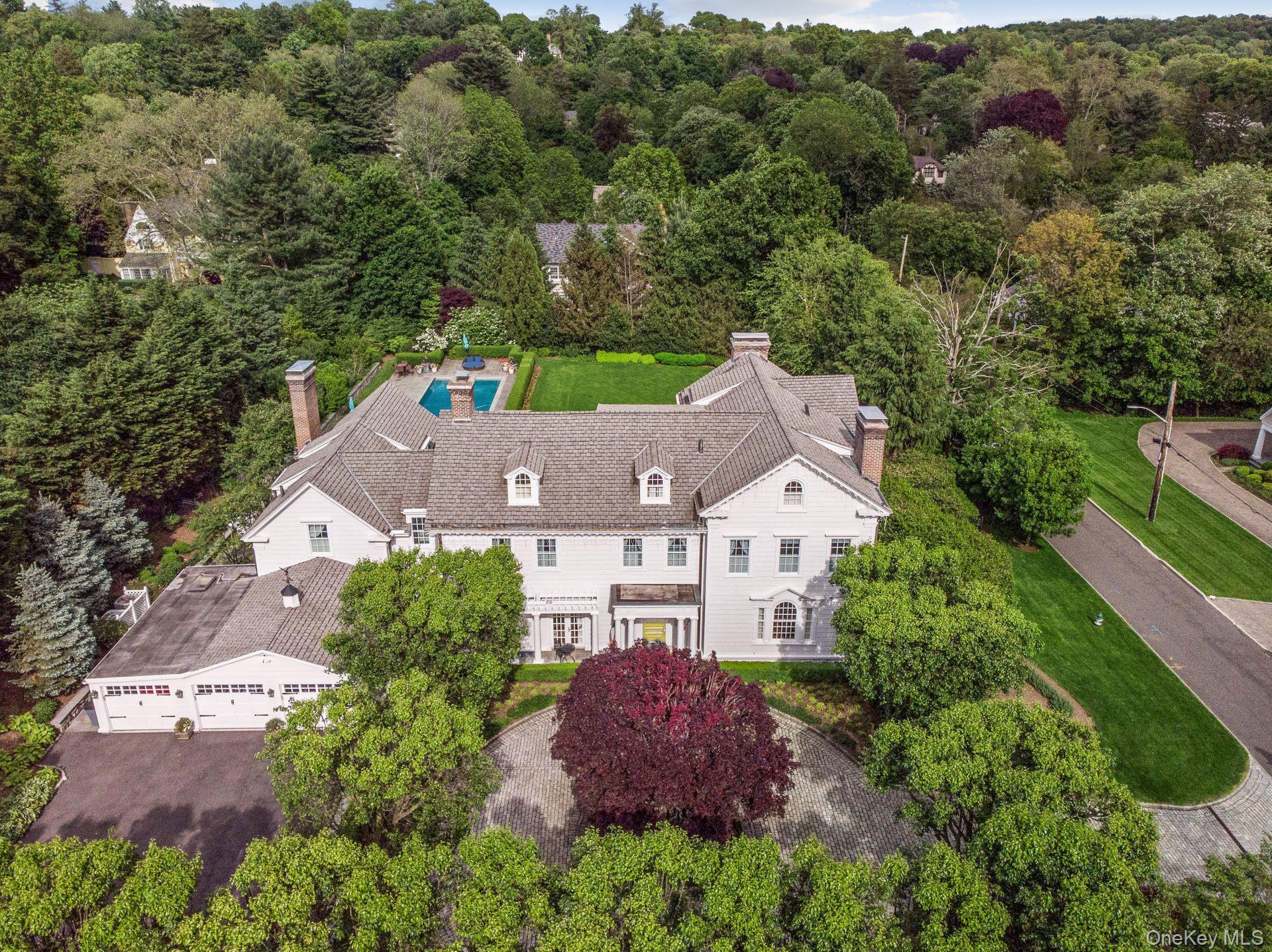 Step into timeless elegance in Ardsley Park at this exquisitely renovated 1900 Colonial, where classic architectural details meet artisan craftsmanship and thoughtful modern upgrades. Set on a full acre of impeccably landscaped grounds with specimen plantings and multiple patios, this exceptional home offers both privacy and convenience—just minutes from the Villages, train, schools, restaurants, parks, and more.  Arrive through a sweeping courtyard to a three-car garage and discover over 8,000 square feet of beautifully appointed living space. With eight bedrooms, seven bathrooms, and eight fireplaces, the home is designed for both grand entertaining and comfortable everyday living.
Every day can feel like a getaway—swim in the heated in-ground pool, dine al fresco under the stars, enjoy a movie in the theater, savor a glass from the wine cellar, play a round in the billiard room, or unwind with a steam after a workout in the private gym.
This is more than just a residence—it’s a lifestyle where every luxury is at your fingertips, all in the heart of one of Irvington's most sought-after neighborhoods.