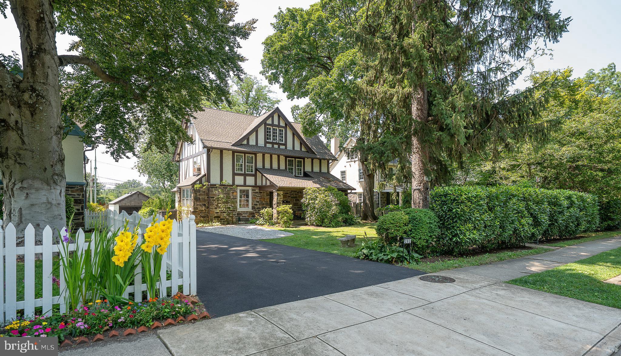 Colonial, center hall Tudor style three story, 6 bedroom, 3400 sqft house with covered front porch, large stone wood burning FP, central air, family room off the kitchen w powder room and two car detached garage. Pretty, private rear patio and fenced back yard all in one of the Main Line's most cherished family neighborhoods.Enter the front portico to the gracious, wide center entrance hall. Living room to the right has fireplace and large windows with pretty hardwood floors. Coat closet under transverse stair.  Dining room to the left has bench seating under bright sidelight windows with pretty views. Dining room opens to butler's pantry with storage closets and cabinets with sink. Pantry opens in turn to the full eat-in kitchen and family room with powder room. Family room opens out to  rear outdoor patio, which steps down to the back lawn.  Wide set front steps up to second floor. Owners bedroom has full, en-suite bathroom, bright windows, closets and hardwood floors. Two additional family bedrooms share a full hall bathroom. Second floor laundry.Steps up to third floor, which has three additional, generously-sized, bright family bedrooms that share a full hall bathroom.Full, unfinished lower level has storage and mechanicals, with bilco door and walkout steps up. Walk to SEPTA's Wynnewood train station, Suburban Square, LMHS athletic fields and tennis courts, Narberth Boro, Whole Foods & Trader Joe's, Starbucks and Wynnewood Shopping Center, just around the corner.