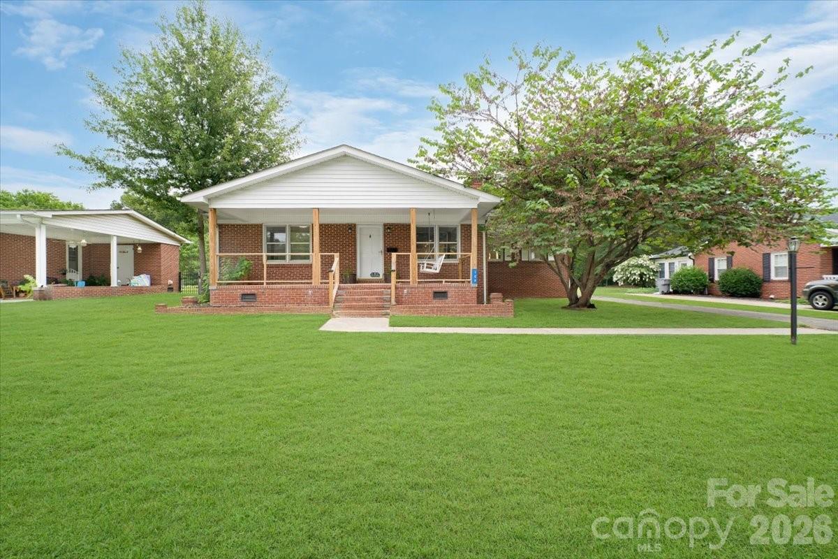 Welcome home to this beautifully maintained all-brick ranch nestled on a charming tree-lined street in the heart of downtown Clover. Enjoy the convenience of being just a short walk from locally owned restaurants, boutiques, parks, and everything that makes this historic railroad town so special. Whether you're grabbing breakfast at a neighborhood favorite, meeting friends for dinner, or simply enjoying an evening stroll, you'll love the walkable small-town lifestyle this location offers.Situated on nearly a half-acre of level, usable land, this property provides a rare combination of space, privacy, and convenience. Inside, you'll find a thoughtfully designed floor plan featuring two spacious bedrooms, two full bathrooms, and fresh paint throughout, creating a bright, move-in-ready interior. The inviting living area is centered around a cozy gas fireplace, while the updated kitchen and bathrooms showcase numerous thoughtful improvements, including new cabinet hardware, upgraded drawer slides, and convenient pull-out shelving and storage baskets in the lower kitchen cabinets and primary bath.The major updates have already been completed, offering peace of mind for years to come. The roof is only four years old, the HVAC system is just seven years old, and recent improvements include new garage doors, one with an automatic opener, a new water heater, garbage disposal, refrigerator, range, and dishwasher, along with numerous additional updates throughout the home.The front-load washer and dryer convey, and the television with the shelf below is also expected to remain, making this home even more move-in ready. Outside, you'll appreciate the attached two-car garage as well as a spacious 16' x 20' storage building/workshop, providing endless possibilities for hobbies, storage, or a dedicated workspace.Combining timeless all-brick construction, modern updates, an exceptional lot, and one of Clover's most desirable downtown locations, this home offers an opportunity that's becoming increasingly difficult to find. Schedule your private showing today and discover everything this wonderful property has to offer.