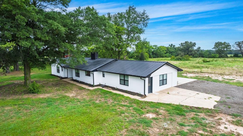 Located in the award-winning Como-Pickton school district on 5.78 acres, this home was extensively updated! Owners took this down to the studs, and beyond, in order to rebuild this home with attention to detail. Not many original pieces are left from 1975. The primary ensuite features a soaking tub, dual sink, separate walk-in shower, plus a spacious walk-in closet. The living room comes with a large brick wall, an accent wall, and a wood burning fireplace. An open kitchen includes a farmhouse sink under a beautiful picture window with a view of the beautiful northeast Texas land. Also in the eat-in kitchen, open to the dining area, you'll find granite countertops, an island, stainless steel appliances, and a pantry with sliding barn doors. Enjoy a MASSIVE bonus room with outside access that could be a 4th bedroom, 2nd living room, game room, or flex space. Additional touches include recessed lights throughout, luxury vinyl plank flooring, ceiling fans, metal roof, and picturesque tract with trees. From the backyard, you can view the scenics pastures and shady acreage, with fruit trees and berry shrubs. Plus plenty of pasture for whatever livestock you desire. Shop can be built for around $30,000