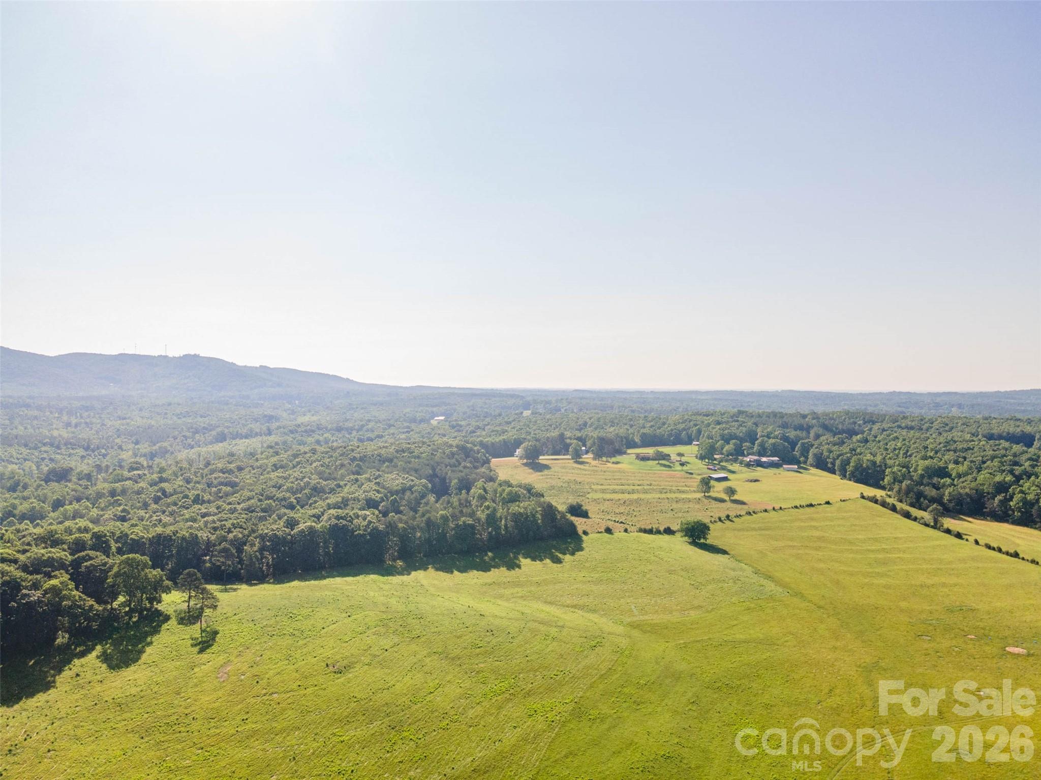 89-ACRE WORKING CATTLE FARM with Mountain Views, Pond & Farm InfrastructureDiscover the possibilities on this beautiful 89 acre working cattle farm offering a blend of productive pastureland, scenic beauty and country living. Featuring fantastic mountain views, a year-round stream and a pond, this property is well equipped for livestock operations and ready for your vision.This farm includes two wells, one for the home and one for two automatic livestock waterers, quality pasture acreage, a large hay storage building, an old barn full of character, and a substantial 28.5 x 40 metal building/workshop ideal for equipment, storage, maintenance or hobby use.This property also features a 3 BR, 1 BA brick ranch with a full basement. While the home is in need of renovations, it provides an excellent opportunity to restore, expand or create your dream farmhouse overlooking the picturesque countryside.Whether you're looking to expand your cattle operation, establish a horse farm, create a private family estate with multiple homesites or invest in a rare piece of mountain-view farmland, this unrestricted property offers endless potential.