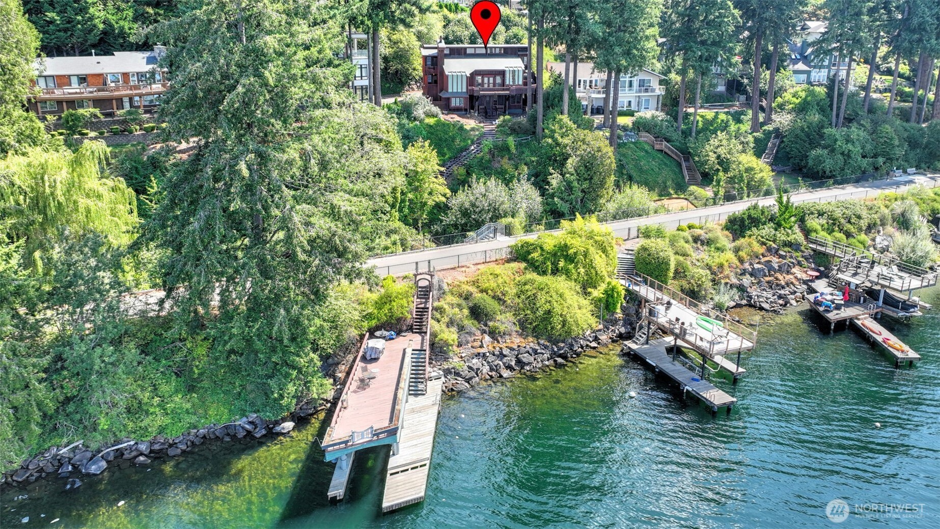 Experience the best of Lake Sammamish living with 80 feet of prime waterfront, breathtaking panoramic views, and an impressive approximately 1,000-square-foot boathouse dock designed for boating, paddleboarding, swimming, and endless summer fun. This beautifully maintained home offers over 3,000 square feet of living space on a lot just shy of a quarter acre, creating a rare opportunity to own affordable waterfront in one of the Eastside’s most desirable locations. The main kitchen features a Sub-Zero refrigerator and stunning lake views, while the lower level includes a second full kitchen—ideal for extended guests, multigenerational living, or potential rental income. Thoughtful upgrades include fresh exterior and interior paint, a new high-efficiency heat pump providing year-round heating and cooling, a durable copper shingle roof, and custom handmade exterior doors that add timeless character. The attached two-car garage offers everyday convenience, and the expansive outdoor spaces invite you to entertain or simply relax while taking in spectacular sunsets over the water. Located within the highly acclaimed Issaquah School District, this is an exceptional opportunity to enjoy the waterfront lifestyle you’ve always dreamed of. Easy access to the 11 mile long East Lake Sammamish Trail!