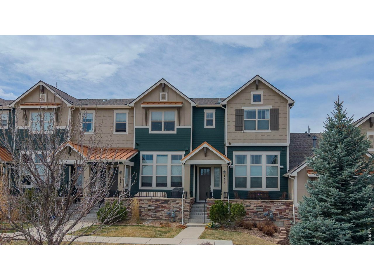GREAT NEW PRICE! Located in one of Louisville's most desirable pockets-and arguably one of the best locations in Steel Ranch South-this former model townhome offers a beautiful blend of space, comfort, mountain views and easy Colorado living. With over 2,300 square feet, 2 bedrooms, 2.5 baths, and an attached two-car garage, there's plenty of room to live and entertain. Step inside from the slate entry and you're immediately welcomed by dramatic cathedral ceilings and a beautifully upgraded spaced flooded with natural light. This model features the largest kitchen plan, offering abundant storage, a walk-in pantry, and generous counter space. The kitchen is a true standout, complete with quartz countertops, soft close drawers and roll outs, a custom copper backsplash, stainless steel appliances, and a large center island-opening seamlessly to the dining and main living areas for a connected, inviting feel. Additional upgrades include theater lighting, custom stair railings, surround sound speakers, air filtration system and tankless water heater. Upstairs, the primary suite offers a comfortable retreat with vaulted ceilings, a private bath, generous closet space and adjacent laundry room. The second bedroom enjoys great light and views, with plenty of room for guests or family, while the loft provides flexible space for a home office or reading area-and could easily be converted to a third bedroom. The lower level and attached two-car garage provide additional storage and functionality, and the overall layout offers that sought-after single-family feel with the ease of townhome living. Set within a quiet, well-maintained community built in 2013, this home is ideally located with easy access to trails and open space, as well as all that makes Louisville so special - from local dining and shops to Main Street, nearby parks, and recreation. Convenient access to both Boulder and Denver completes the package.