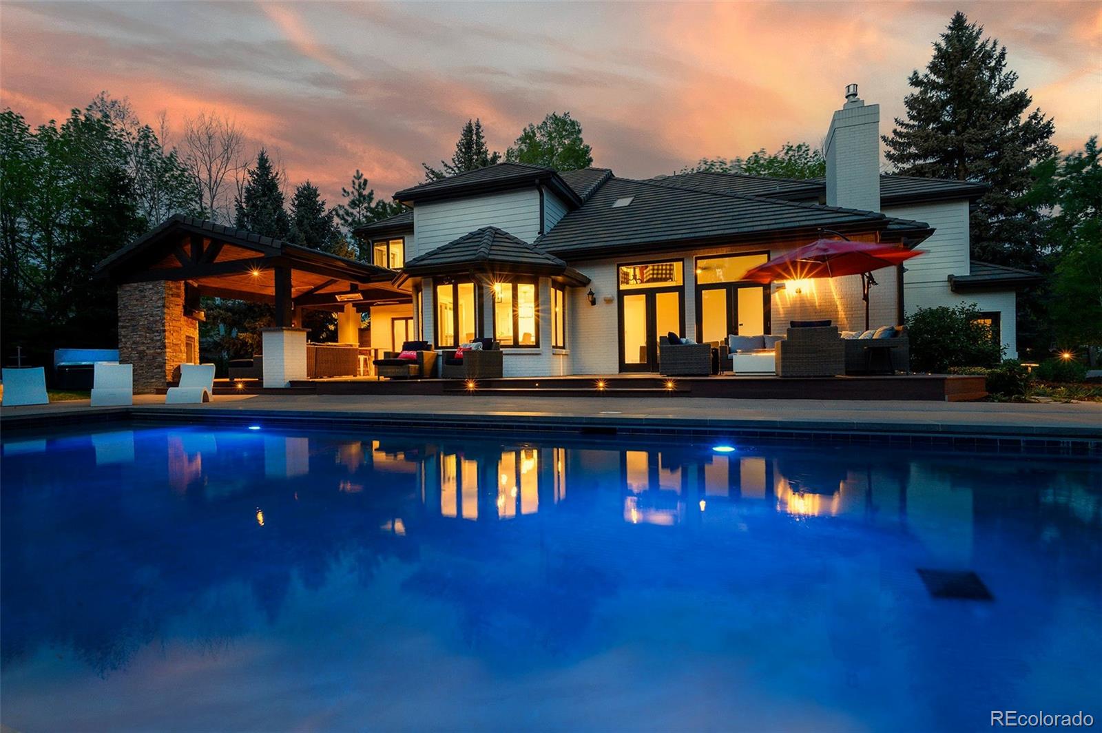 Welcome to the luxury oasis at 5345 S Race Ct—an exquisite and fully updated 4-bedroom, 5-bathroom estate nestled at the end of a peaceful cul-de-sac in the heart of Greenwood Village. This 6,627 sq ft residence sits on a lush, park-like 1-acre lot and has been thoughtfully renovated to elevate both style & function. Refined finishes, soaring ceilings, & picturesque views of the beautifully landscaped grounds are focal points of this beautiful home. A stunning remodel centered around a fully reimagined kitchen, creates a seamless flow anchored by custom high-end cabinetry, premium quartz countertops, and top-of-the-line gourmet Miele appliances including; dual microwave/steam/convection ovens & induction cooking range. Natural light floods the open-concept living area, w/ a gas starter wood burning stone fireplace, custom screen, and Samsung Frame TV. The main floor has a separate great room & living room, an office (or extra bedroom) w/ private access to a 3/4 bathroom. Upstairs you are greeted w/ new carpet in all 4 Bedrooms, updated bathrooms w/ new vanities, fixtures & flooring. The oversized basement is complete w/ full bathroom, new carpet and paint. This spacious area features a pool table and plenty of space for entraining and watching Colorado's favorite sports teams. Step outside into the backyard paradise featuring a heated pool with retractable safety cover, 8 person Caldera Hot tub, a covered outdoor sitting area w/ stone fireplace, and a gourmet outdoor kitchen complete with built-in Memphis pellet smoker/grill. The new wraparound deck effortlessly connects the indoor and outdoor spaces, making this home ideal for hosting and enjoying the outdoor Colorado lifestyle. Located just steps from the High Line Canal Trail and only minutes from Cherry Creek, DTC, & downtown Denver. This exceptional home offers privacy, convenience, and resort-style amenities in one of Greenwood Village’s most desirable neighborhoods. https://www.youtube.com/shorts/bd9HNqv98ps