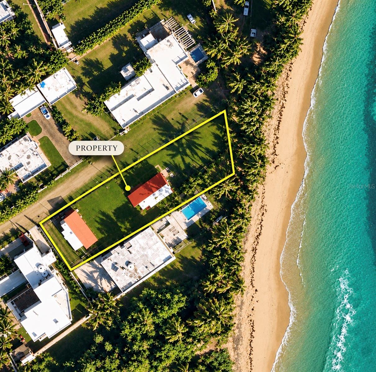 Beachfront property for sale in Río Grande, Puerto Rico, on the shore of Las Picuas Beach. This rectangular oceanfront lot of 1,013.87 sq m (about 10,913 sq ft) includes two campers with wooden decks already built, each with 2 bedrooms and 2 bathrooms, plus a third hookup ready for a third camper. Located in an urban-tourist area of vacation resorts and private homes, minutes from El Yunque National Forest, championship golf, horseback riding, river kayaking, and the ferry to Vieques. About 30 minutes from San Juan's SJU Airport (22 mi) and 45 minutes from Old San Juan (32 mi). A strong fit for a vacation rental, tourism investment, or a beachfront getaway in Puerto Rico's northeast coast.