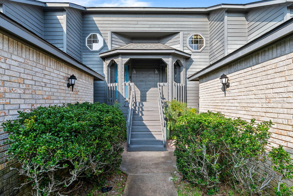 Natural light, privacy, and a unique layout set this Oak Bay condo apart. Tucked into a more private setting within the community while still offering convenient access to the Rockport Country Club golf course, this 2-bedroom, 2.5-bath split-level condo offers 1,467 square feet designed for comfortable coastal living. Step upstairs into a bright, airy main living space where abundant natural light fills the open living and dining areas. Raised ceilings and a wood-burning fireplace add character, while the adjoining sunroom creates the perfect spot for a home office, reading nook, or additional sitting area. The primary suite is located on the main living level with a private bath and walk-in closet. Downstairs, the guest suite feels like its own private retreat, complete with an en-suite bath, separate private entrance, and its own patio which is ideal for visiting family and friends or anyone wanting a little extra independence and privacy. Enjoy multiple outdoor spaces, access to the community pool, and two assigned parking spaces, including one covered space. With its abundance of natural light, thoughtful separation of spaces, and tucked-away location near the golf course, this Oak Bay condo offers a combination of privacy and convenience that's hard to find.