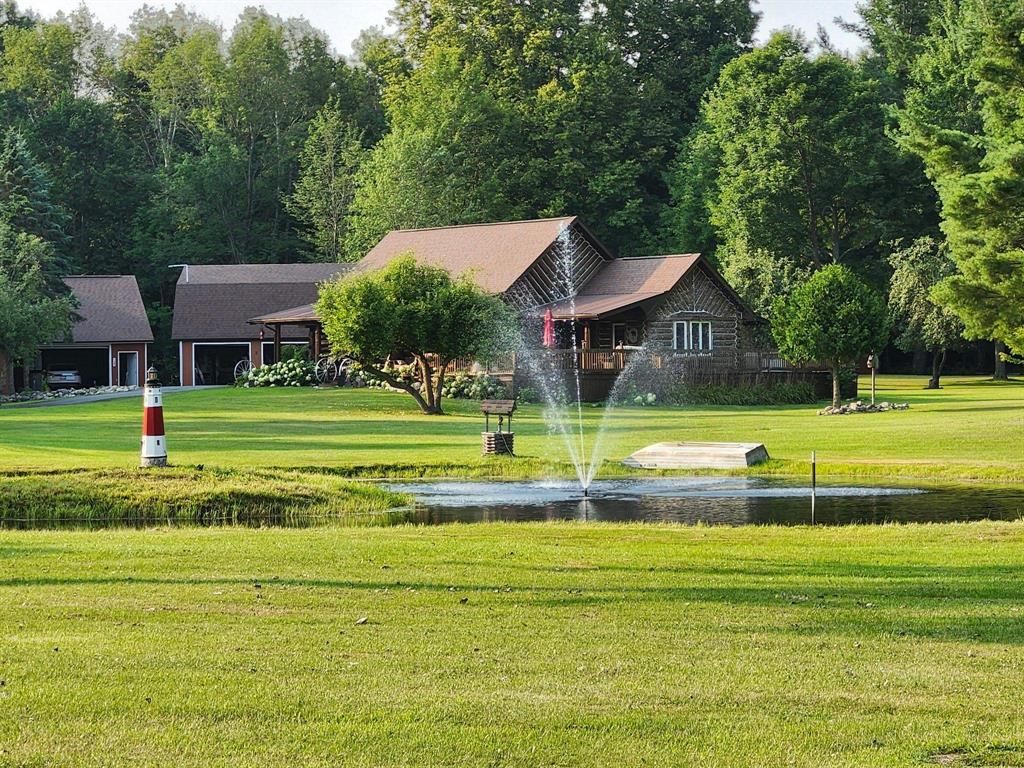 Beautiful log house w/pond & 2-garages, a guest house for extra guest or rent out, a must see on 20-acres, pond is stocked w/blue gill & bass.