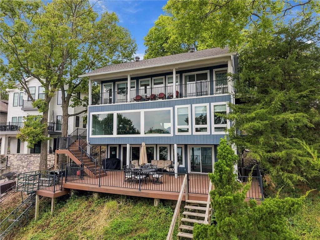 Wake up to sweeping main channel views and end every day on a large composite deck made for entertaining, morning coffee, and watching the boats go by. This Lake Lotawana retreat puts the water front and center from the moment you arrive.Getting to the water is half the fun. A motorized tram carries you and your guests up and down the hill, so groceries, gear, and grandparents all make the trip with ease. At the bottom, a shared deep water dock offers your own boat slip plus an additional slip for the fishing boat, so you can be on the water in minutes.Inside, the home offers two bedrooms and three baths on the main levels. The finished basement adds a non-conforming third bedroom and a kitchenette, ideal for overnight guests, a game-day hangout, or a private hideaway after a long day on the lake.Lake life isn't a weekend getaway here. It's home.Seller is open to selling all furniture, pontoon boat, and fishing boat separately.