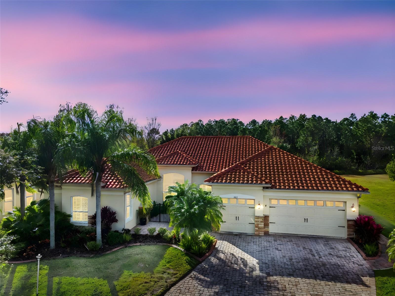 One of Solivita’s Most Exceptional Estate Homes- Offering Unmatched Privacy, Unique Upgrades, & Turnkey Luxury. Located in the prestigious Portofino Estates, this meticulously upgraded residence sits on a rare, oversized, over 1/3 acre PRIVATE lot, backing to BOTH CONSERVATION and WATER- offering complete privacy. (New Tile Roof: 2023) **This home is offered TURNKEY and fully furnished* With over 2,800 sq ft of interior living space and an additional 1,000 sq ft covered and screened lanai, this home delivers an unparalleled indoor-outdoor lifestyle. Walk through your gated front entry & double glass front entry doors, & be welcomed with soaring 12-ft ceilings, elegant architectural details, tray ceilings, crown molding, 5¼” baseboards, custom wall molding, and plantation shutters throughout. The designed interior features 24” porcelain tile throughout the main living areas, rich hardwood in the private office/study, & ultra-plush carpet in the primary and en-suite bedroom. The open living room showcases a custom stone accent wall, large picture windows overlooking the private WATER views, & French doors with built-in interior shades leading to the lanai. The chef’s kitchen features granite countertops, custom tile backsplash, crown-molded cabinetry, under & over-cabinet lighting, & a tremendous picture window overlooking the lanai & private conservation views. The oversized custom island includes a prep sink, wine refrigerator, & abundant counter space, creating a true entertaining hub. The primary suite offers stunning private views & a spa-inspired bath featuring two oversized walk in closets - one being a custom California walk-in closet (measuring an impressive 12’ x 10’), separate & spacious dual granite vanities with unique lighting, garden tub with chandelier, and a tiled Roman walk-in shower with glass partition. The second bedroom includes a private en-suite bath with upgraded tiled shower and large walk-in closet. This home also includes a large custom laundry room with additional cabinetry, sink, closet, and folding space, plus a conveniently located half bath between living areas. Step outside to a fully appointed 1,000 sq ft outdoor living retreat featuring a bar area, designer lighting, outdoor TV, luxury seating, dining space, motorized shades, and electrical already in place for a hot tub. Beyond the lanai is an additional paved patio area overlooking water and conservation. There is also ample space for a future pool. Major upgrades include a 2023 barrel tile roof, impact windows & doors, newer HVAC, new refrigerator, & a full three-car garage with epoxy floors and stand up attic storage. Every detail of this home has been thoughtfully curated—custom, refined, and unlike anything else in the community. From molding and cabinetry to lighting, finishes, and layout, this residence reflects an exceptional level of craftsmanship and care. Solivita offers endless amenities including 14 heated swimming pools, indoor pool & indoor walking track, state of the art fitness centers, 17 pickleball courts, lighted tennis courts, two 18-hole Championship golf courses, over 250+ clubs to join, 3 community restaurants, Farmers Markets every Monday and Friday, and so much more! Poinciana Lakes Plaza is a MAJOR NEW SHOPPING CENTER that features so many restaurants and shopping. This is a rare opportunity to own one of the most upgraded, private, and distinctive estate homes in Solivita—offered fully furnished and move-in ready.