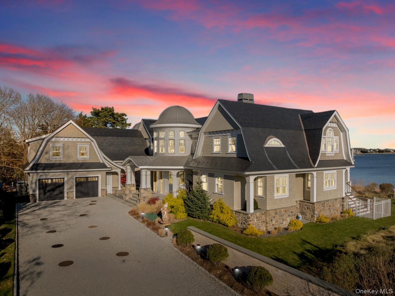 Set on 175 feet of private sandy beachfront with a 136' dock, this Shinnecock Bay waterfront residence is designed to highlight its panoramic setting and create a natural flow between interior spaces and the surrounding landscape. Multiple elevations and extensive glasswork frame open bay views from morning through evening, emphasizing light, orientation, and connection to the water. The open-concept main level includes a chef's kitchen with Wolf appliances, pantry, and a wall of glass doors that transition to the full-length mahogany deck, extending the living area directly toward the bay, infinity-edge pool, and spa. The first-floor waterfront primary suite features two walk-in closets, a spa bath with jacuzzi, and private access to the deck. A separate guest suite with private entrance, powder room, mudroom, and attached two-car garage complete the main level. The second floor offers a junior suite with terrace, a dedicated office, and a secondary living area with direct access to the upper full-length deck. Two additional en-suite bedrooms with walk-in closets, a laundry room, and a second powder room provide flexibility and privacy. Both levels include expansive rear decking, maximizing outdoor circulation and enhancing the home's orientation toward the bay. Situated south of the highway, the home is just minutes to marinas, beaches, and area dining, supporting both seasonal and year-round use. Homes offering this combination of substantial water frontage, docking capability, and modern construction are limited, making it a notable opportunity for buyers seeking direct waterfront access. This residence brings a rare alignment of features together in one setting, providing a practical and well-connected entry point to the Hamptons' coastal lifestyle.