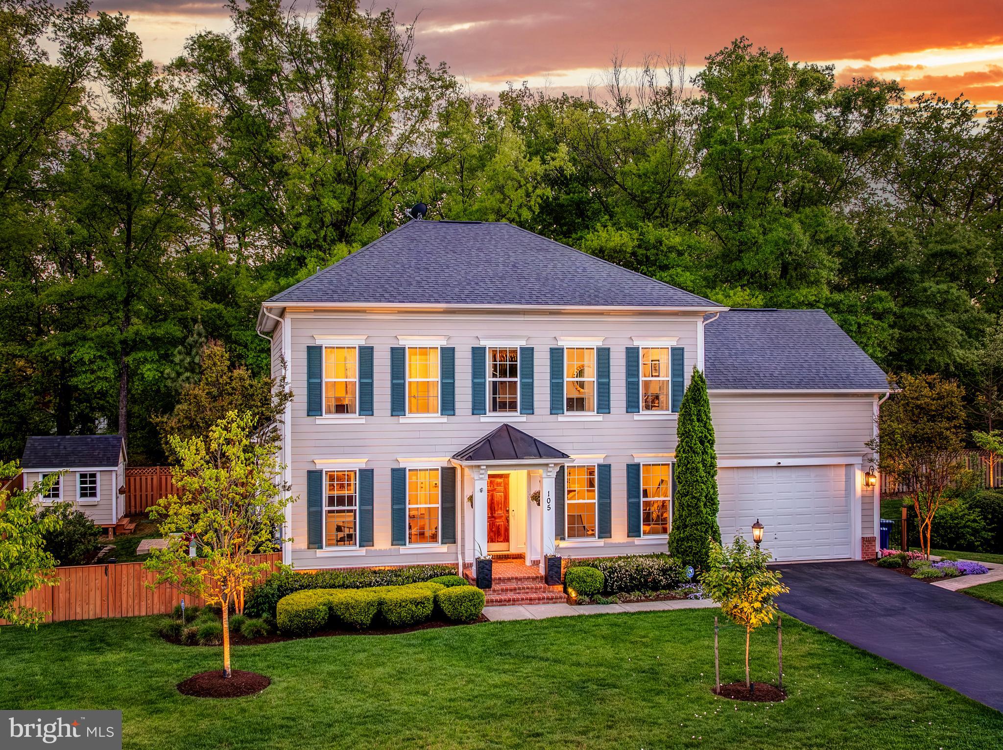 Set at the end of a quiet cul-de-sac in Van Buren Reserve, a small enclave of just nine homes with no HOA, 105 Heglar Oaks Ct has the kind of setting that is increasingly hard to find in Herndon: private, polished, and close to everything without feeling like it is in the middle of everything. Built by Evergreen Homes in 2015, this Craftsman offers over 4,000 finished square feet across three levels with five bedrooms, four and a half baths, a two-car garage, and a floor plan that gives everyone room to spread out without wasting space. The main level feels open, warm, and easy to live in, with hardwood floors, fresh paint, updated light fixtures, generous windows, formal living and dining rooms, and a large family room with a gas fireplace just off the kitchen. The kitchen is the kind of space people actually use, with a huge quartz island, 42 inch white perimeter cabinetry, gas cooktop, vent hood, wall oven, and plenty of cabinet and counter space for cooking, hosting, homework, coffee, wine, or whatever the day calls for. Just beyond the kitchen and family room, the outdoor living is a major part of the home’s personality, with an enclosed sunroom, screened porch, open porch, deck, patio, extensive hardscaping, beautiful landscaping, a fully fenced backyard, and a 2024 hot tub that makes the yard feel like a true extension of the house. Upstairs, the primary suite gives you real breathing room with a tray ceiling, custom closets, and a beautifully finished bath with Carrara tile, a sunken soaking tub, seamless glass shower, and dual sink vanity with quartz top. One secondary bedroom has its own ensuite bath, which is perfect for guests or anyone who wants their own space, while the other two upstairs bedrooms share an updated bath with a dual sink vanity. The lower level adds the flexibility buyers always ask for and rarely get this comfortably, with tall ceilings, recessed lighting, a large rec room, full bedroom, full bath, walk-up exit to the backyard, and a huge storage room. Since being built, the home has been thoughtfully maintained and improved with 2024 sump pumps, a 2023 washer and dryer, 2024 interior paint, 2024 custom closets, 2024 light fixtures, a 2023 security system, and a 2024 hot tub, with the roof, HVAC, windows, and water heater dating to the original 2015 construction. The location ties it all together: minutes to downtown Herndon for local restaurants, coffee, events, parks, playgrounds, and the W&OD Trail, close to Reston Town Center for dining, shopping, fitness, concerts, seasonal events, and year-round energy, less than two miles to the Silver Line Metro, about a six-minute drive to the station, and about 10 minutes to Dulles International Airport, with quick access to Elden Street, Herndon Parkway, Fairfax County Parkway, and the Dulles Toll Road. It is newer construction, real square footage, no HOA, a quiet cul-de-sac, and a private backyard, all in a location that makes daily life simple.