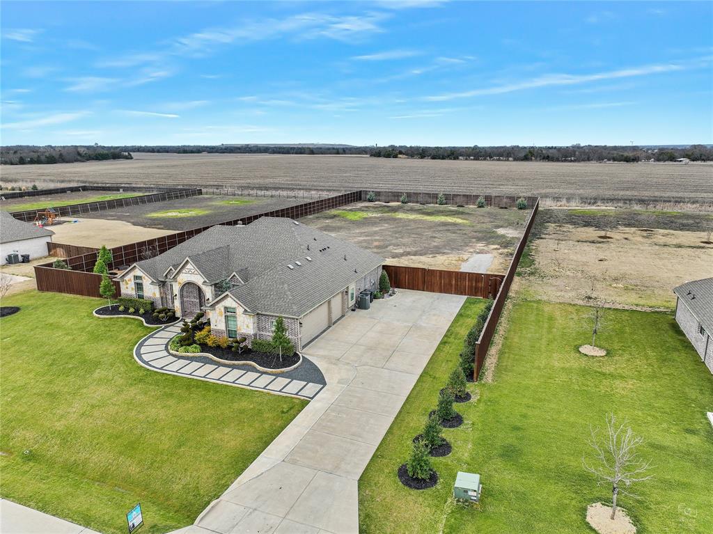 6309 Starr Drive, McKinney, TX 75071No neighbors behind! Yes you can have chickens. Welcome to your private retreat on 1.181 acres in McKinney ISD with an incredibly low 1.33% tax rate.This beautifully maintained property offers the perfect blend of thoughtful upgrades, functional improvements, and outdoor living designed for the Texas lifestyle.The recently painted interior feels fresh and inviting, complemented by updated light fixtures, enhanced bathroom mirrors, and ceiling fans in the bedrooms for added comfort and efficiency.Outside, the curb appeal truly shines. Professionally designed natural stone flower beds elevate the front elevation, while established landscaping creates both beauty and natural privacy. A modern sidewalk adds character and functionality, and upgraded exterior lighting enhances the home’s evening presence.The extended driveway provides generous parking, and gutters along with improved drainage systems in the front and side areas ensure proper water management year-round.Step into the spacious backyard designed for both relaxation and entertaining. Enjoy evenings under the covered patio featuring a warm wood ceiling, or tend to your dedicated vegetable garden area complete with its own irrigation system. Additional irrigation supports trees and key landscape areas, promoting long-term health and balance through every Texas season.This is more than a home — it’s a thoughtfully upgraded property with space to breathe, grow, and entertain.