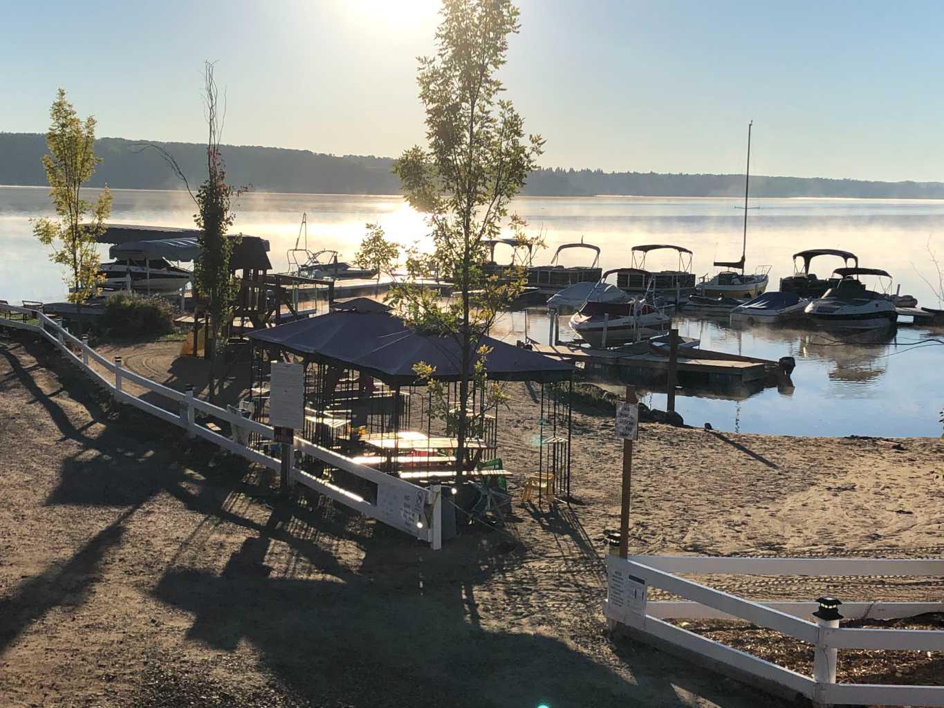Rare opportunity to own a lakeside income property on 1.37 acres at Pine Lake, just 25 mins from Red Deer. This turnkey resort-style package includes a private 25-slip marina with boat launches, 20 leased RV lots, and a 2,600 sq ft walk-out home with two covered decks overlooking the lake. The upper level offers 2 bedrooms plus den, master suite, kitchen, and fenced yard with hot tub. A fully developed side suite provides rental income, while the partially finished walk-out level offers potential for another full suite. The attached garage and separate workshop (with bathroom and laundry for RV guests) add convenience and functionality. All RV lots are leased under low-maintenance agreements providing steady, hands-off income. Private sandy beach, next to Whispering Pines Golf Course—live on the lake, earn income year-round, and enjoy resort living at its best. - Trades Welcome.